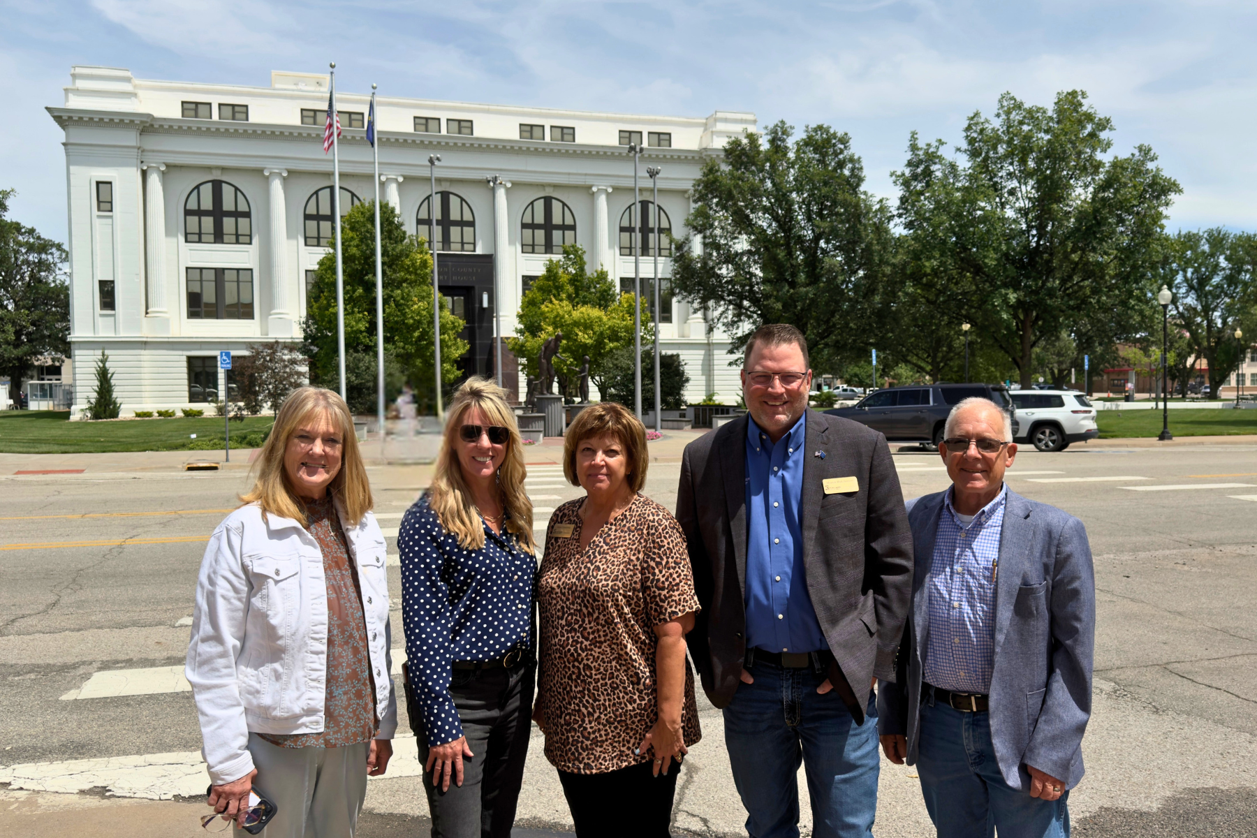Barton County Commissioners pictured outside the Barton County Courthouse as Travel 389 resumes with visits to local businesses.