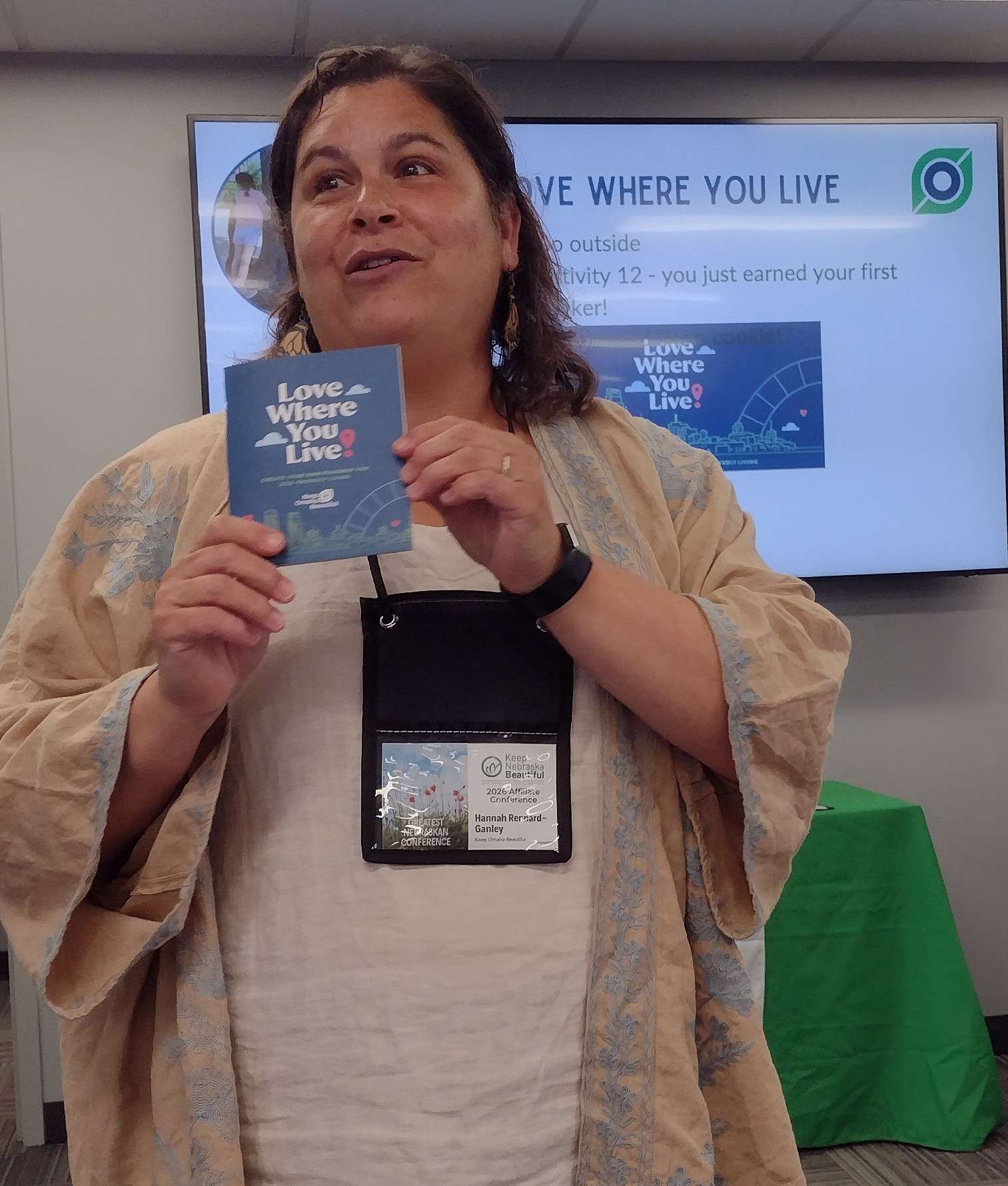 Hannah Rennard-Ganley, with Keep Omaha Beautiful, talks about a booklet on eco-friendly living during the Keep Nebraska Beautiful conference in Lincoln during the first week in June.