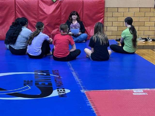 Calie Doze presents safe-dating information as a prelude to a jiu-jitsu class.