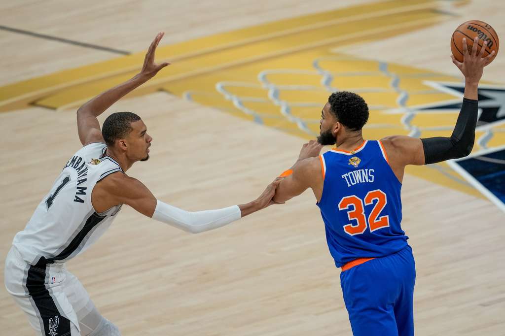 San Antonio Spurs forward Victor Wembanyama (1) defends against New York Knicks center Karl-Anthony Towns (32) during the first half of Game 2 of the NBA Finals basketball series, Friday, June 5, 2026, in San Antonio. (AP Photo/David J. Phillip)