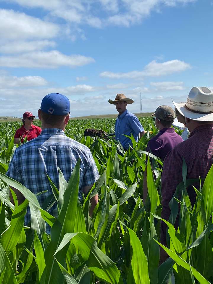Chadron State College alumnus Aaron Hird, center, conducts a Soil Health training at a rangeland site near Brownlee Neb., in July 2021. Attendees include Brad Carlson of Alliance, Neb., and Michael Blount of Ashland, Wis. (Courtesy photo, used with permission)