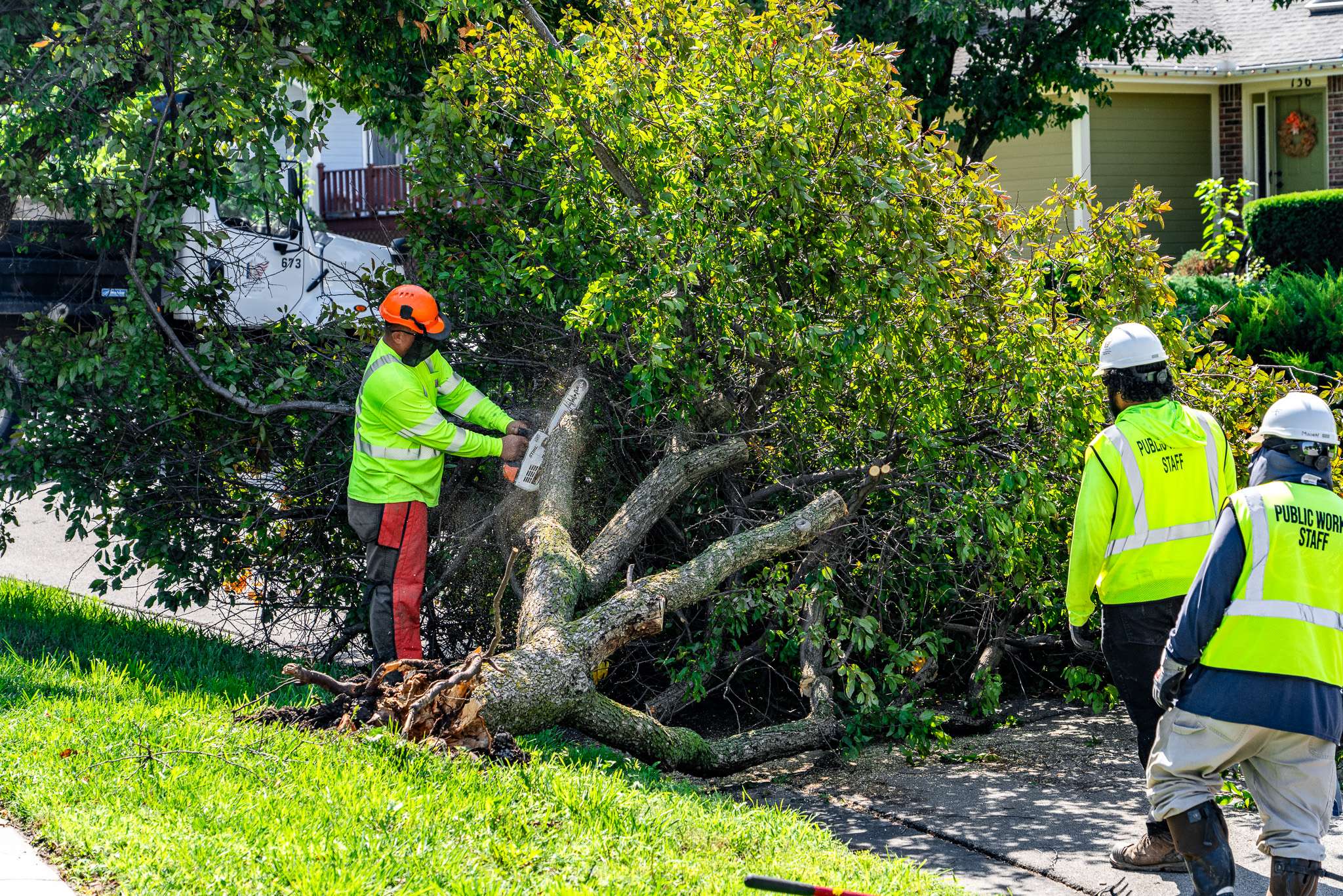 Junction City Public Works Crew cutting up a tree branch blocking the street on Tuesday morning. Photo by Cadin Sanner - Junction City Police Department.