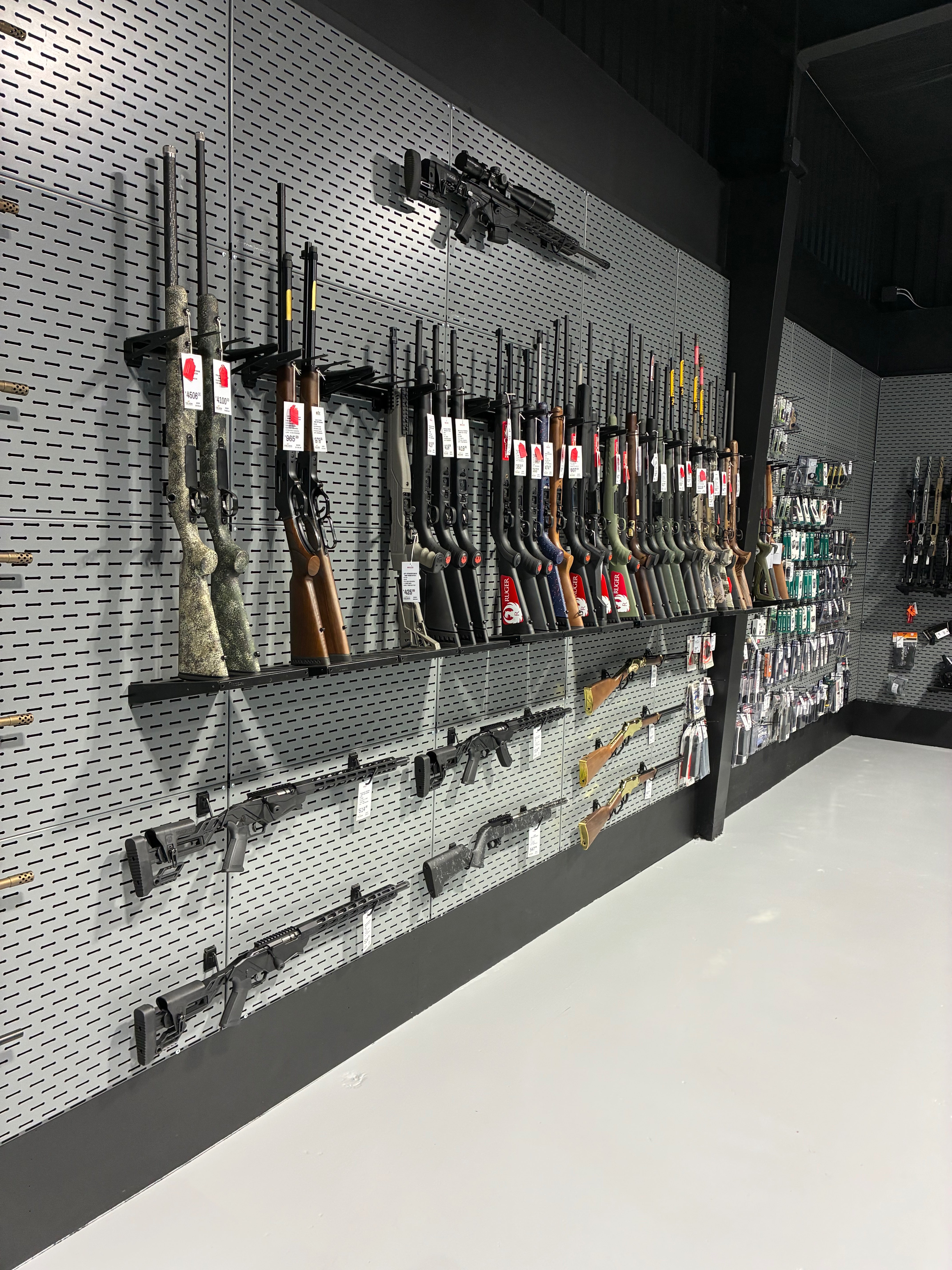 A selection of semi-automatic rifles, including scoped rifles and firearm accessories is showcased inside FASARMS' new storefront. Photo by Alin Hett/Hays Post<br>