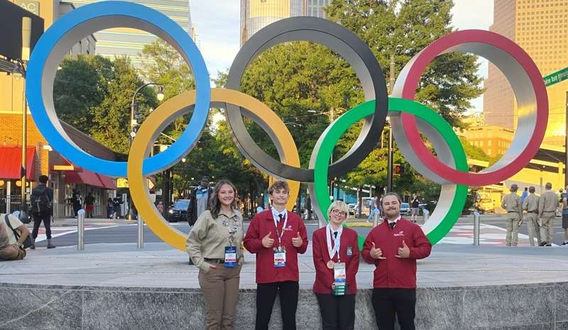 (L to R): Harlie Terrell, Tanner Loughrie, Chyanne Myers, and Blake Beaumont in front of Olympic Park Rings. Atlanta, GA (Courtesy Photo)