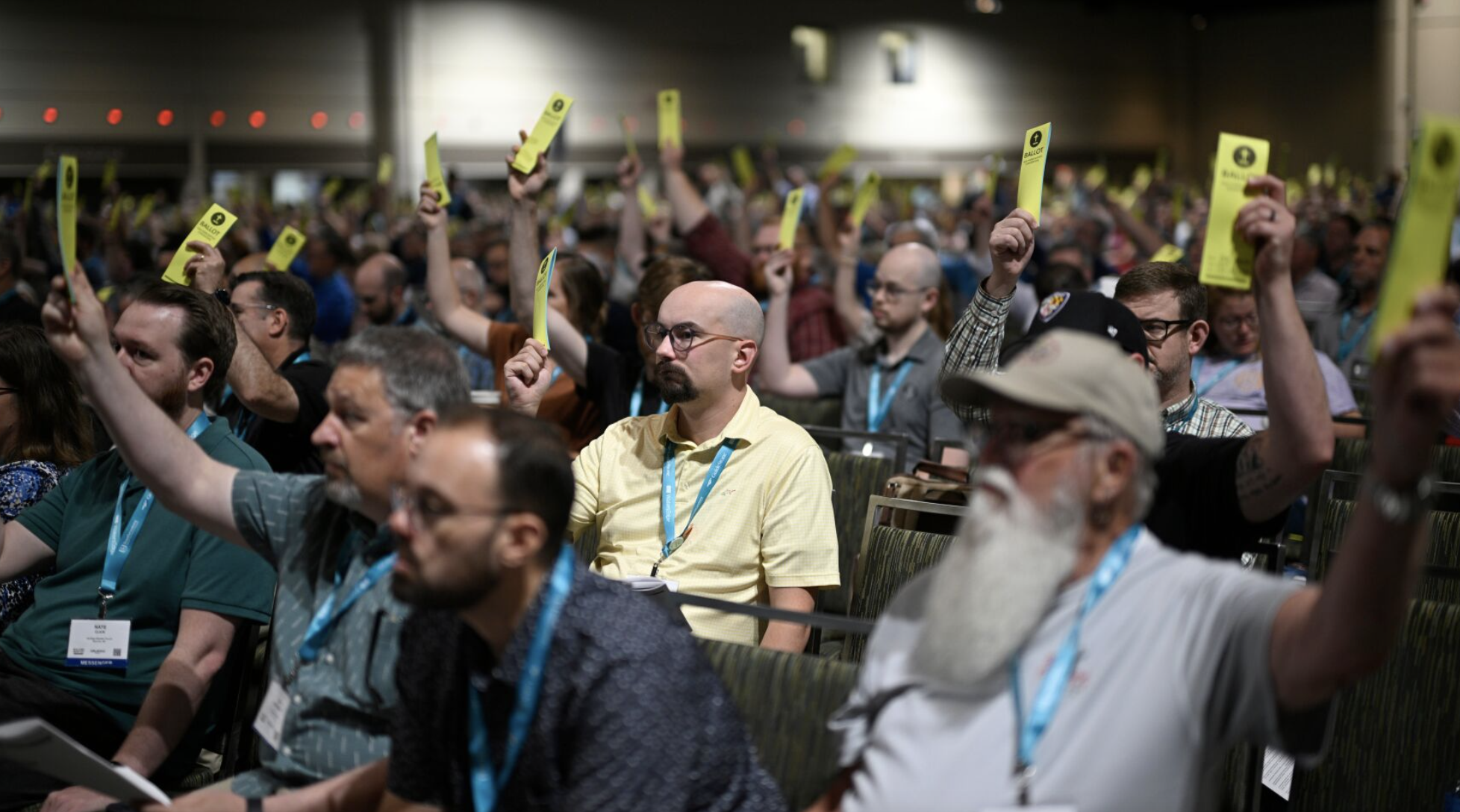 Attendees hold up their ballots while voting on a motion during the annual meeting of the Southern Baptist Convention, Tuesday, June 9, 2026, in Orlando, Fla. (AP Photo/Phelan M. Ebenhack)