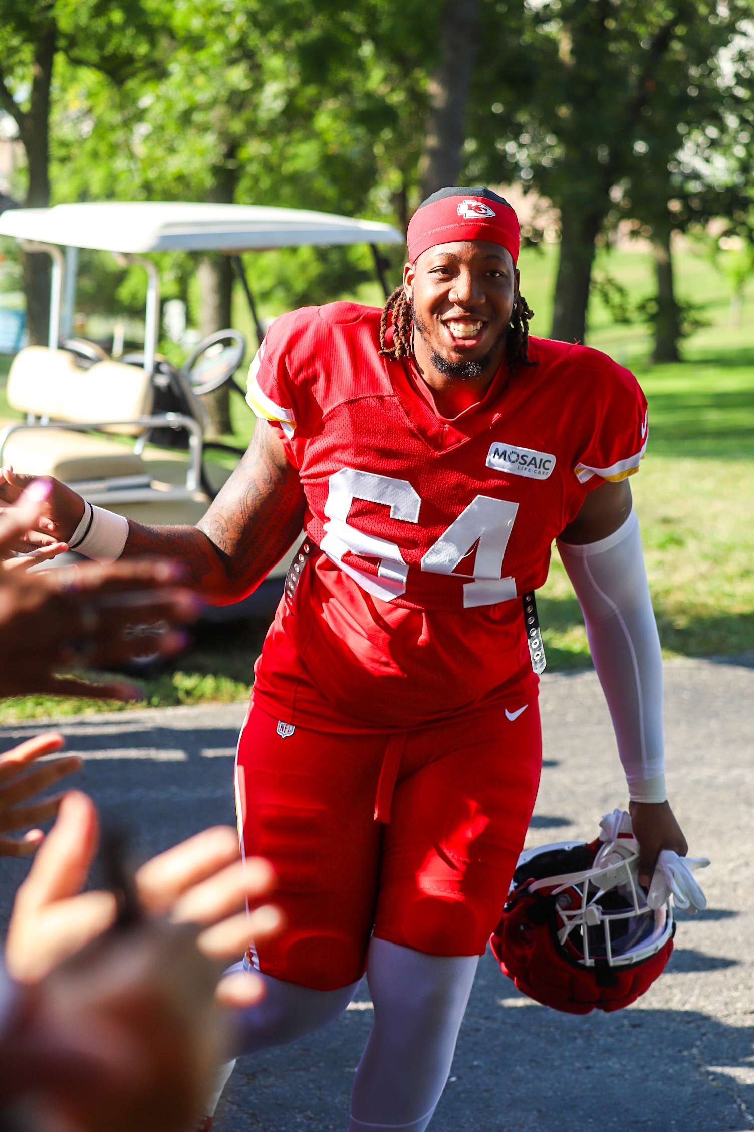 Wanya Morris high fives Chiefs fans as he comes down the hill to practice during 2025 Chiefs Training Camp/ Photo by Alexis Starks