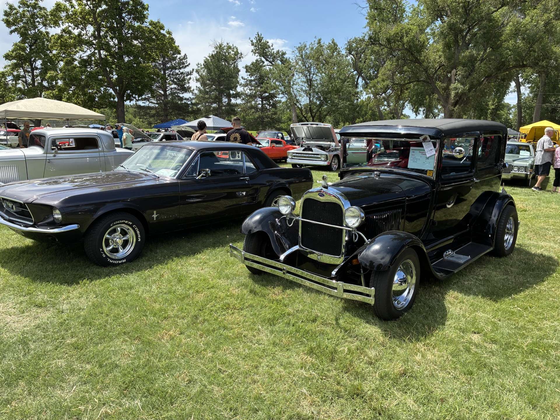 A 1967 Ford Mustang from owner Alec Gerstner next to one of the oldest cars on display at the event, a 1929 Ford Model A Tudor from owner Richard Cox. Photo by Alin Hett/Hays Post