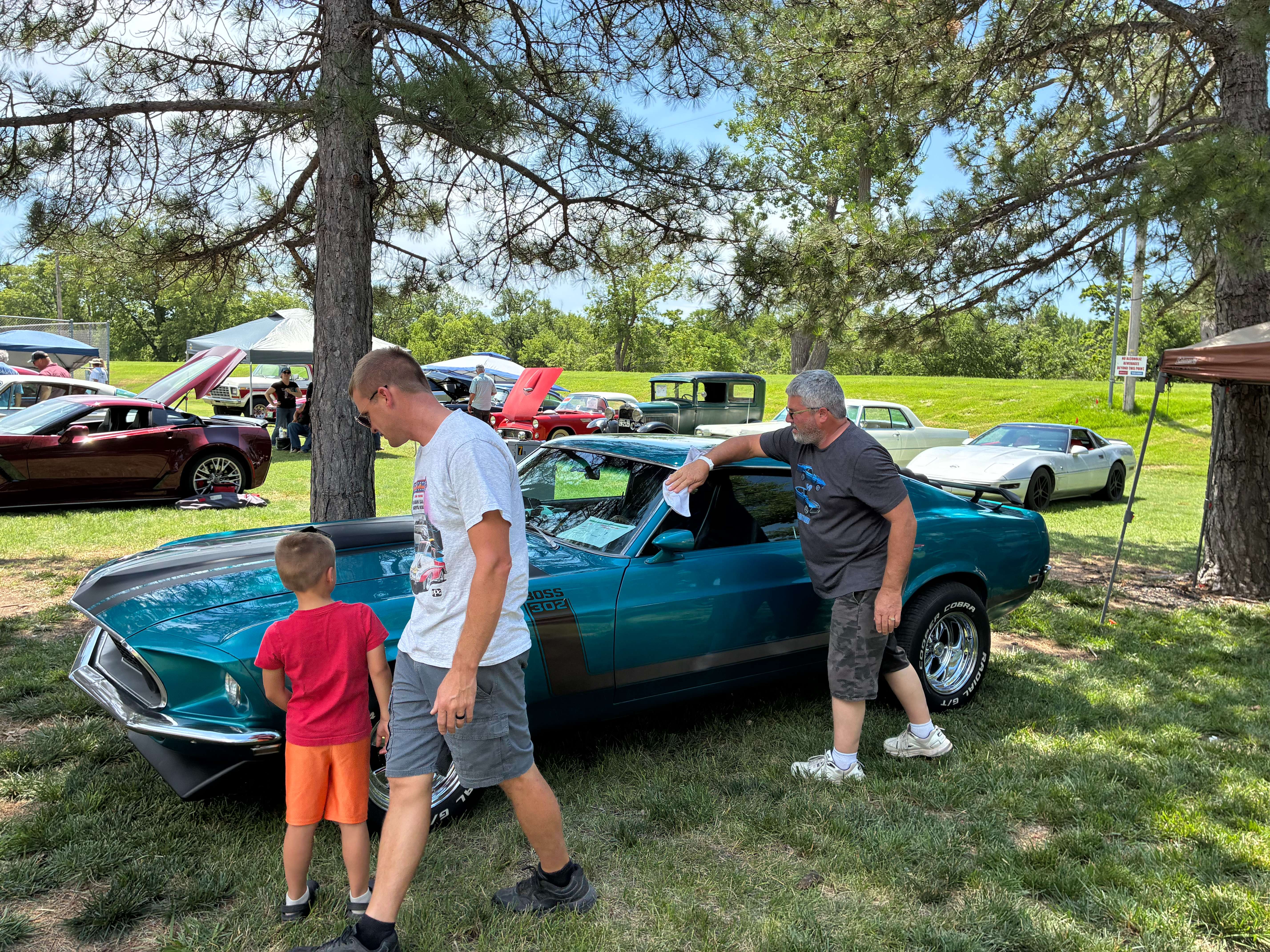 A classic 1969 Ford Mustang being shown to patrons while cleaned by owner Darwin Reuter. Photo by Alin Hett/Hays Post