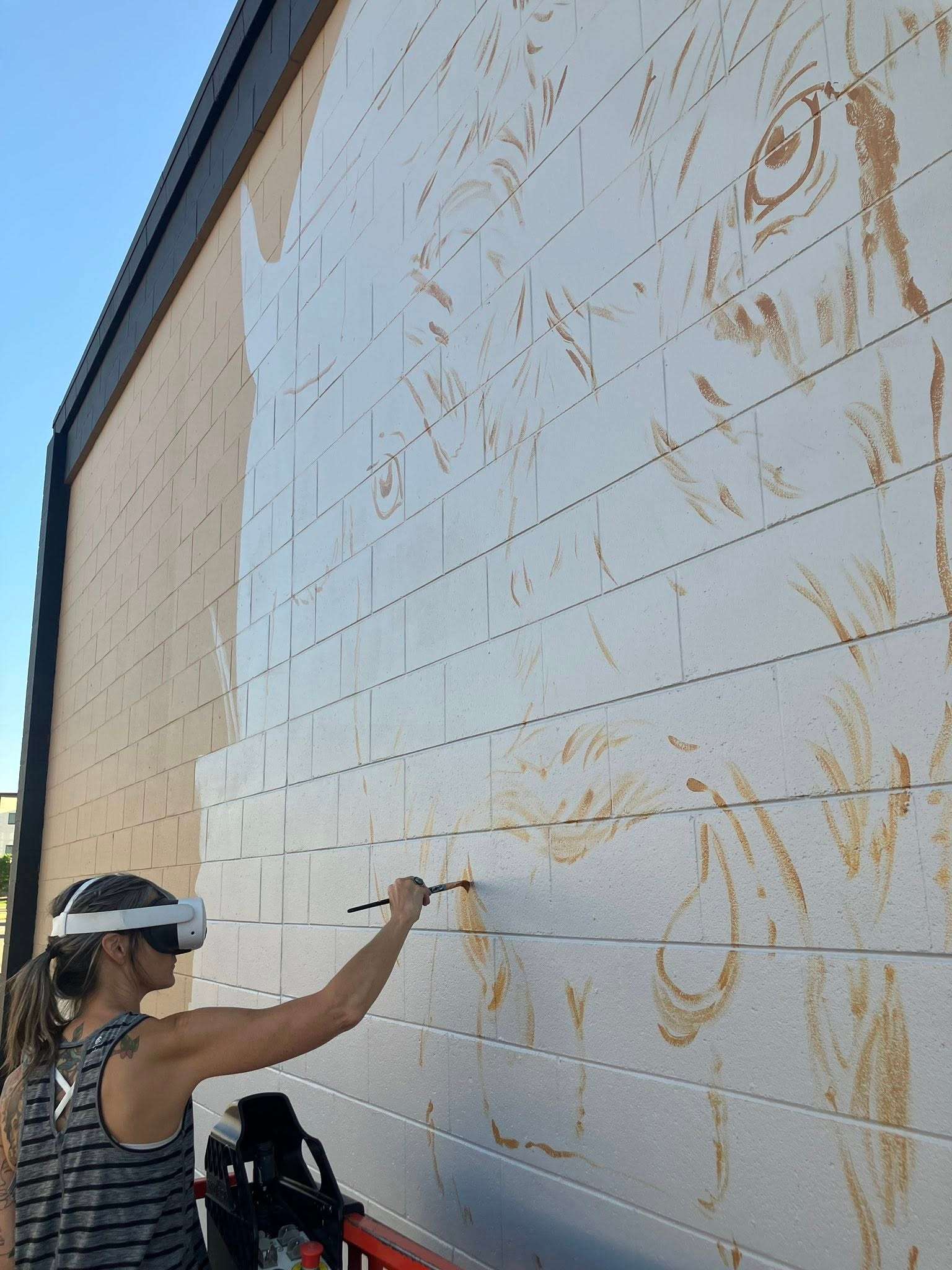 Carlini has many steps to follow through before the projects are complete. In this case, she has drawn a sketch, painted a full version on a smaller scale, and then uses VR headsets to project the drawing onto the larger canvas, the building. 