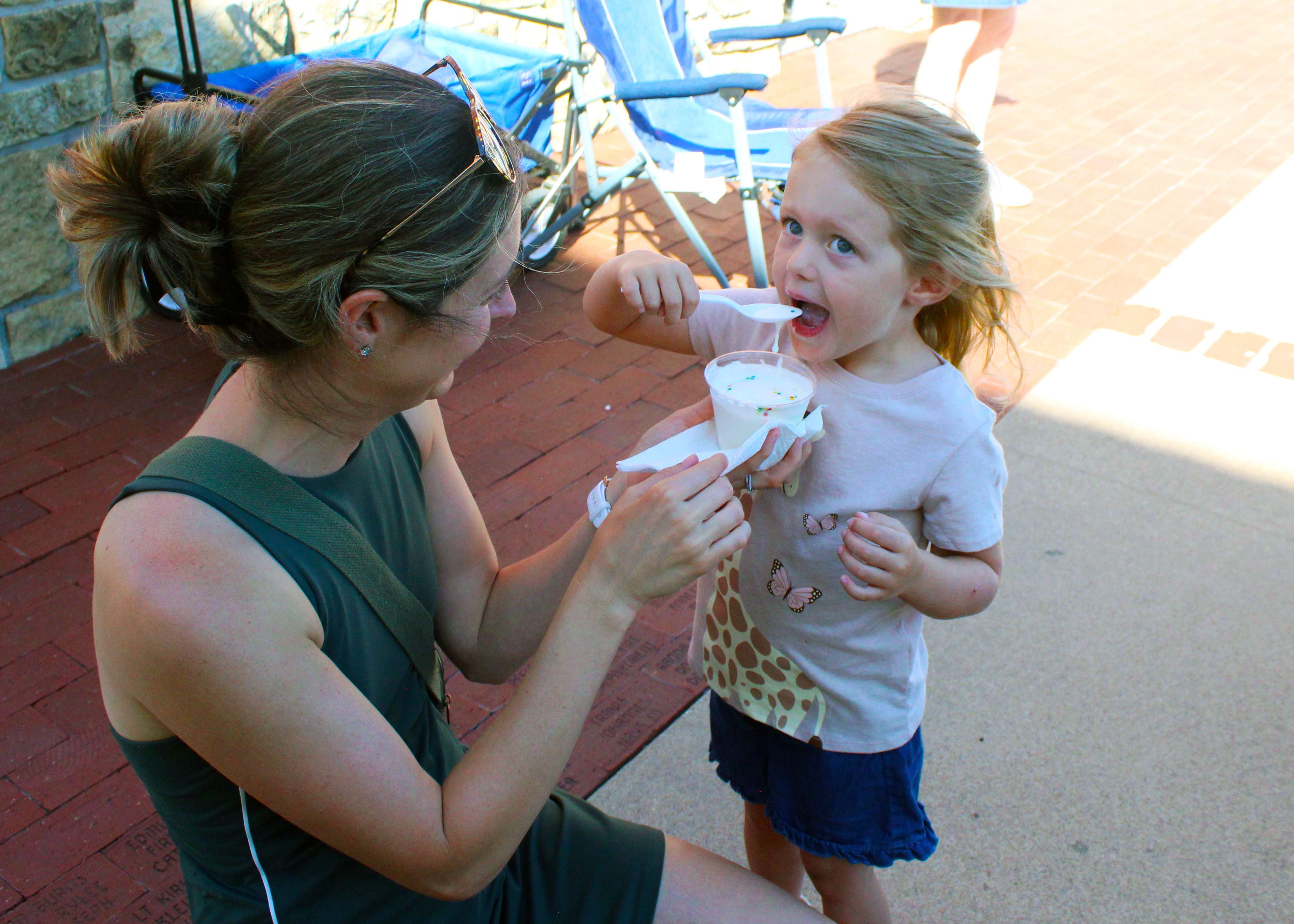 A girl takes a big bite of her homemade ice cream Saturday at Kinderfest.&nbsp;Photo by Cristina Janney/Hays Post