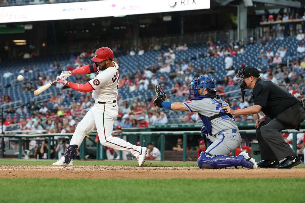 Washington Nationals' Luis García Jr., left, hits a single off Kansas City Royals pitcher Mitch Spence which scored Keibert Ruiz and Nasim Nuñez during the fifth inning of a baseball game, Monday, June 15, 2026, in Washington. (AP Photo/Terrance Williams)