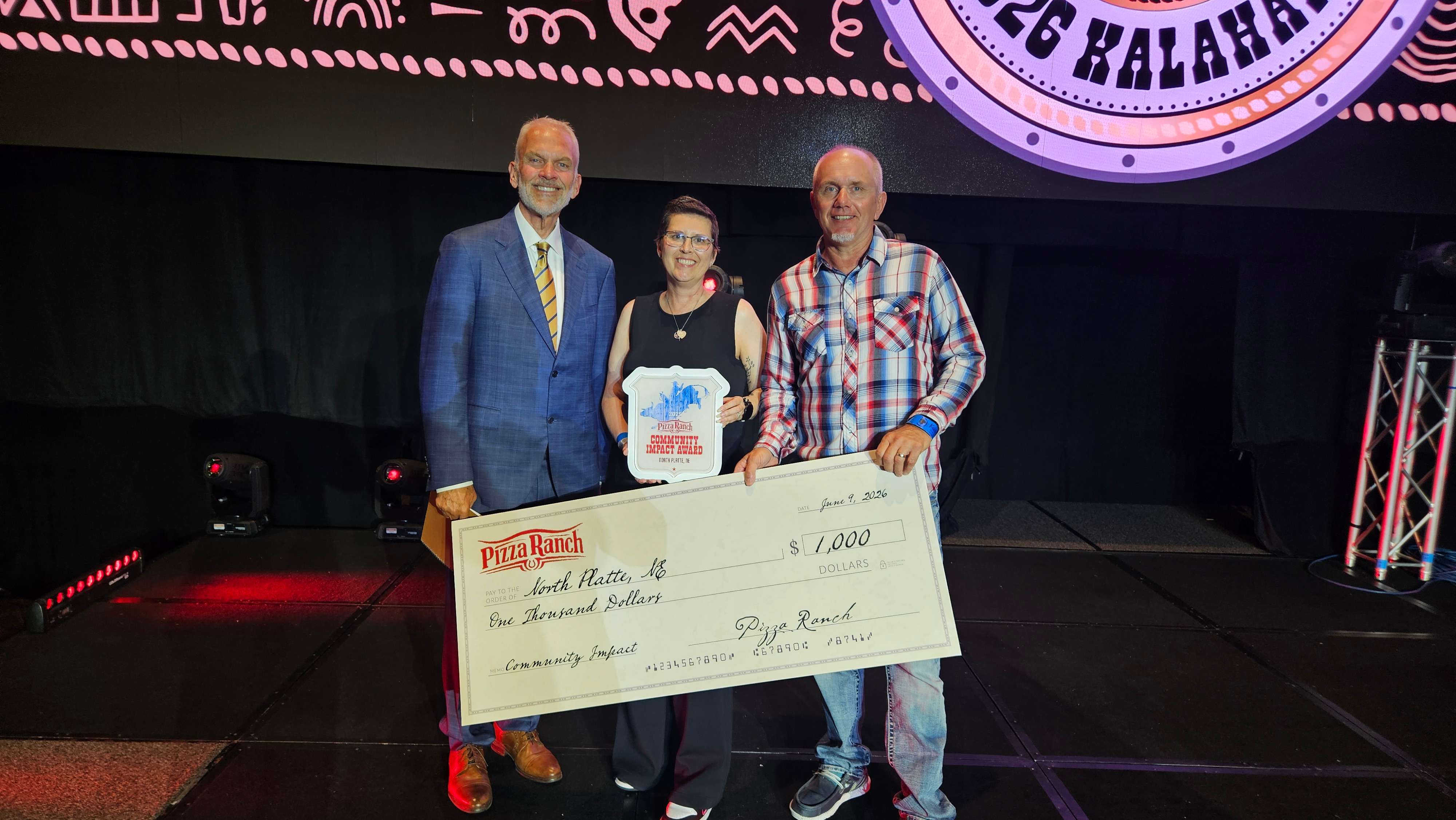 Shae Caldwell of North Platte Pizza Ranch (center) receives Pizza Ranch's 2026 Community Impact Award, recognizing her commitment to community leadership and service. The honor was presented during the Pizza Ranch National Conference at the Kalahari Resort & Convention Center.