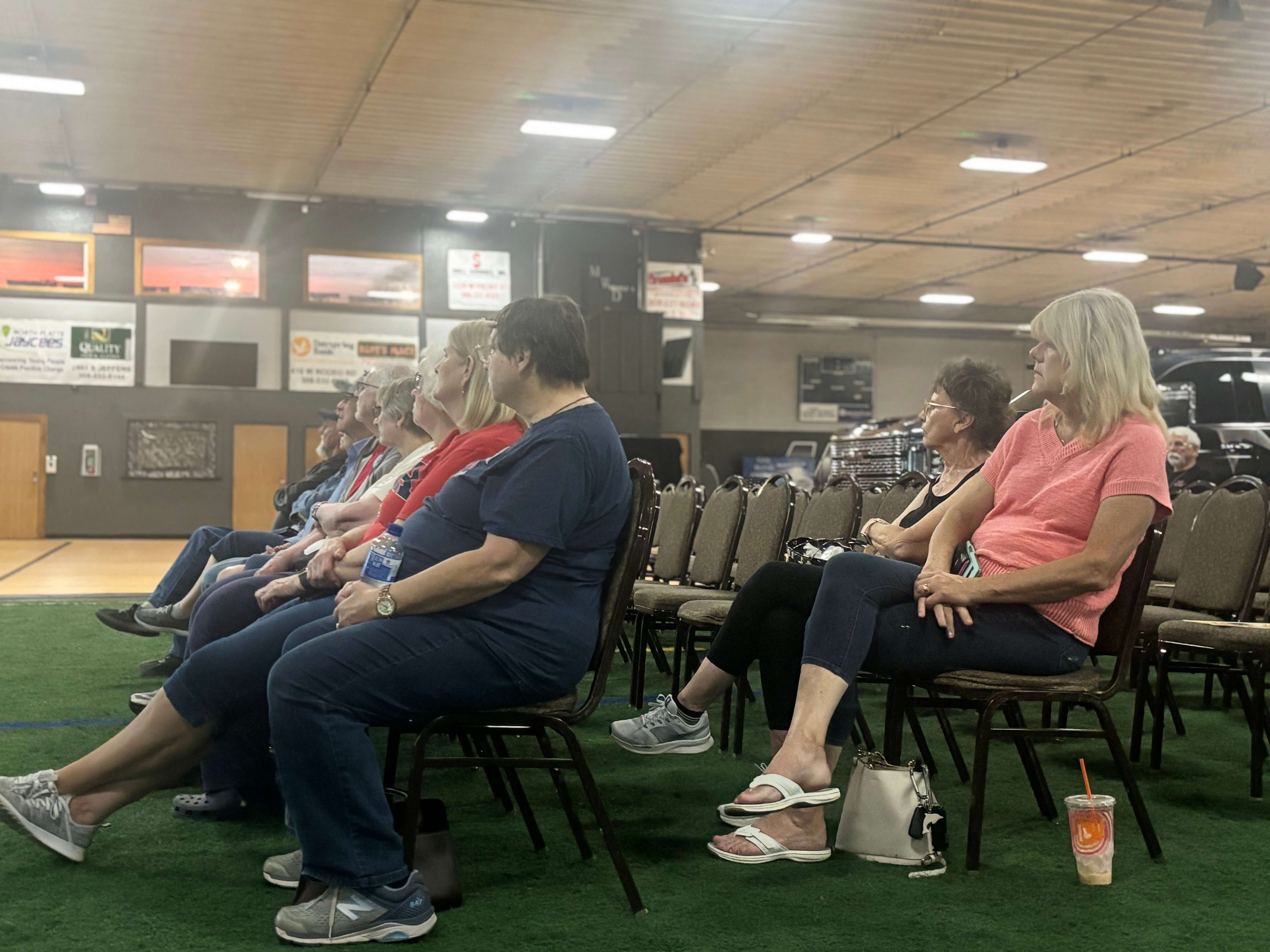 Community members watch the Patriot Thunder Wall of Heroes presentation in North Platte. The traveling multimedia exhibit combines music, lighting, historical imagery and storytelling to honor veterans, first responders and American history. (Allison Peck | The Post)