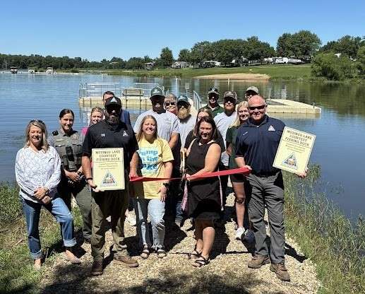 Representatives of Mozingo Lake Recreation Park and MDC recently dedicated the new multi-use dock (shown in background) at the popular 1,000-acre fishing lake in northwest Missouri/ Photo courtesy of the Missouri Department of Conservation