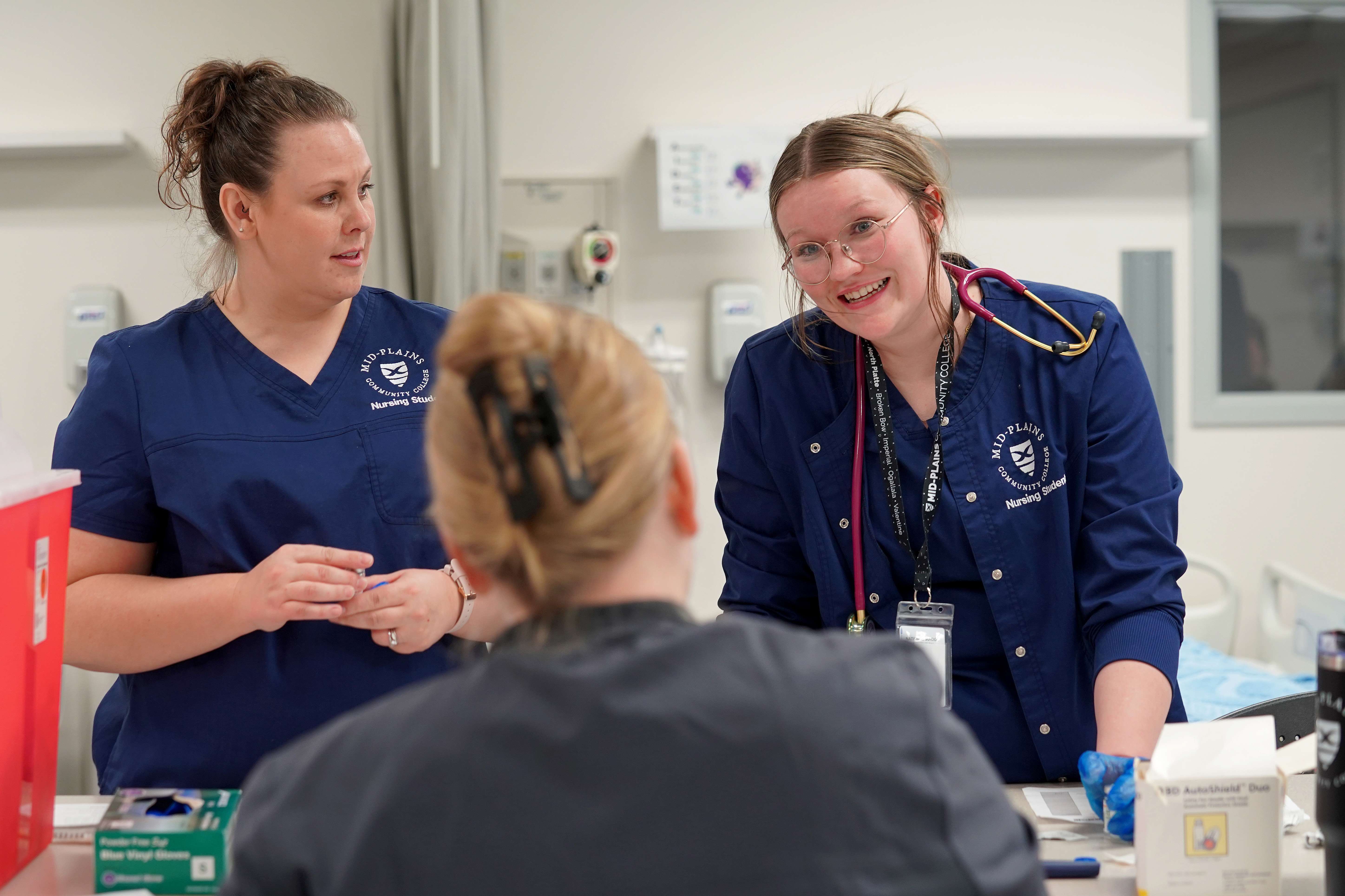 MPCC nursing students Chloe Stehno (left) and Andrea Gray get hands-on instruction during lab in the Health and Science Center on North Platte’s South Campus. (MPCC)