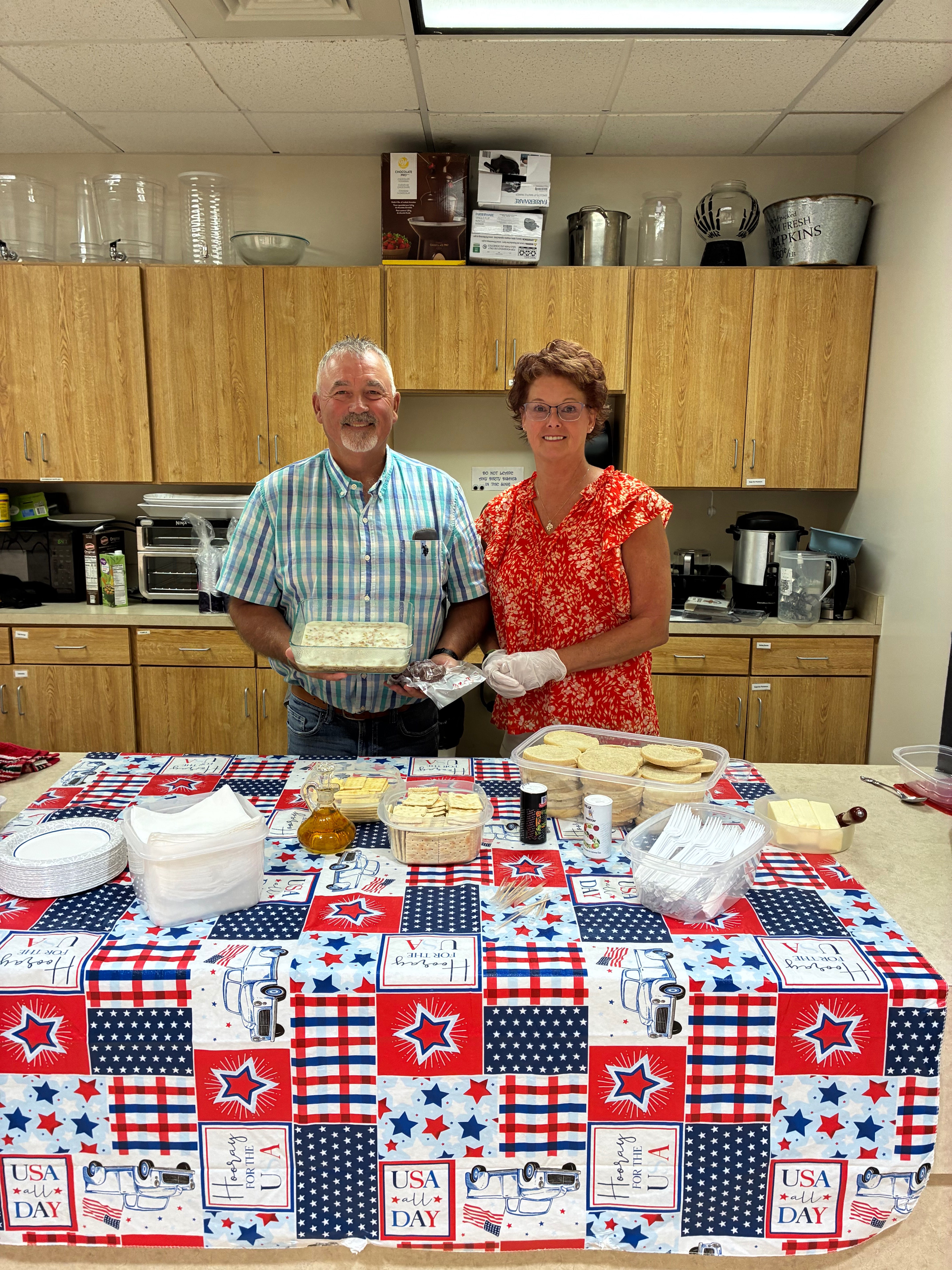 Neal Younger and his wife, Carolyn Younger, pose for a picture featuring traditional and homemade Volga German dishes including galrei and knockwurst. Photo by Alin Hett/Hays Post.&nbsp;