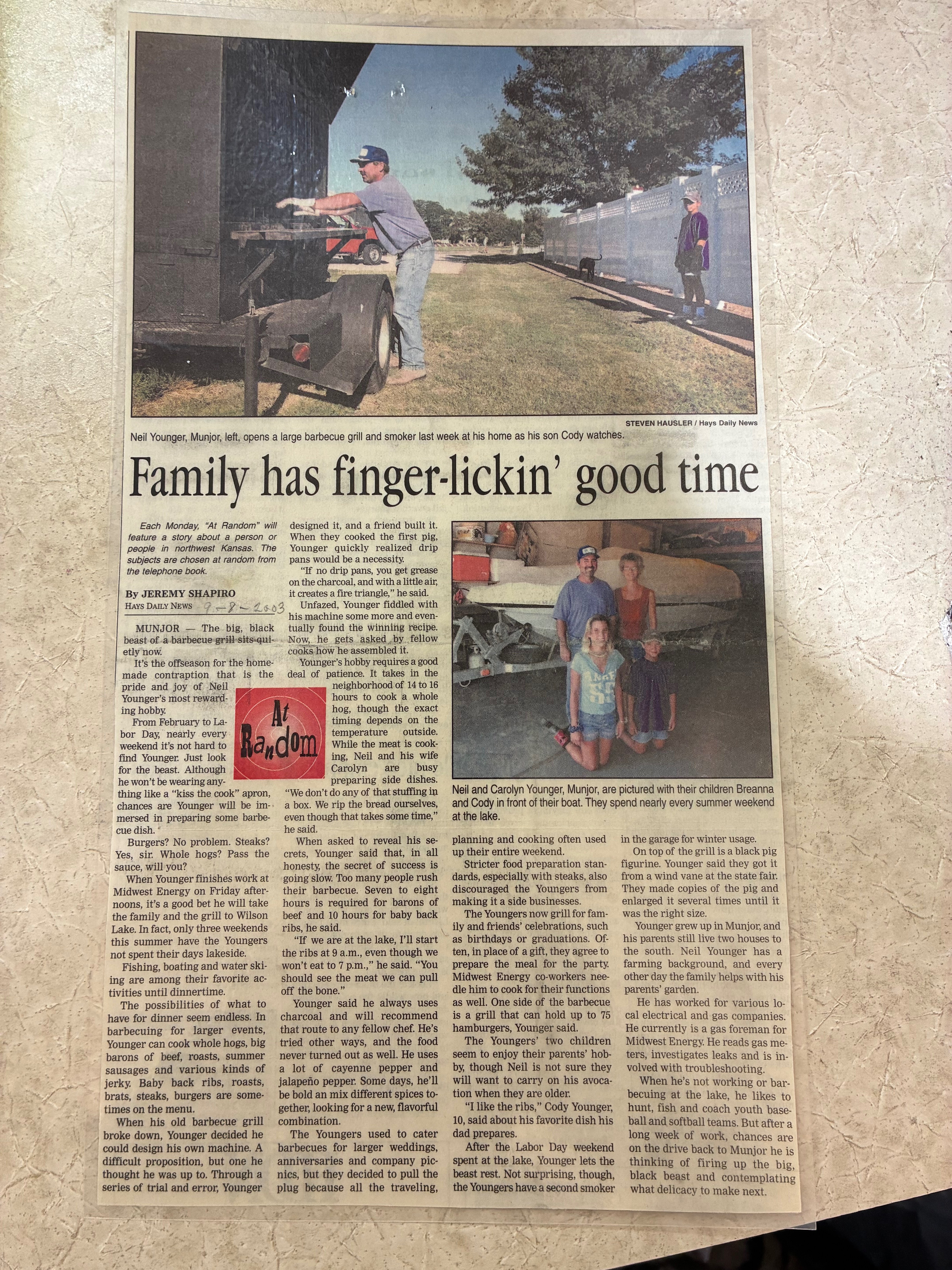 A 2003 Hays Daily News article featured Neal Younger opening his smoker at his home alongside members of his family during his years catering events across Kansas.&nbsp;Photo by Alin Hett/Hays Post.&nbsp;