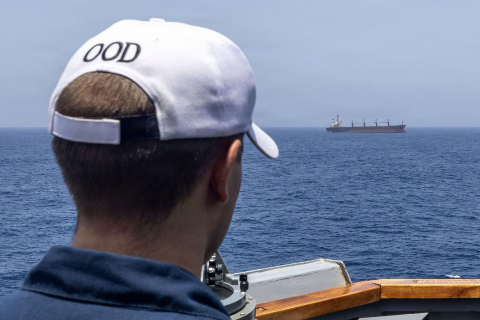 File photo-The officer of the deck aboard USS Michael Murphy (DDG 112) observes a merchant vessel- photo U.S. Central Command