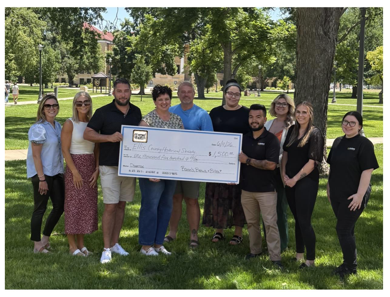 ECHS Director Amanda Rupp and Treasurer Jerry Braun, center, accept donation from Barrels, Brews and Bites Crew including co-lead Philip Kuhn