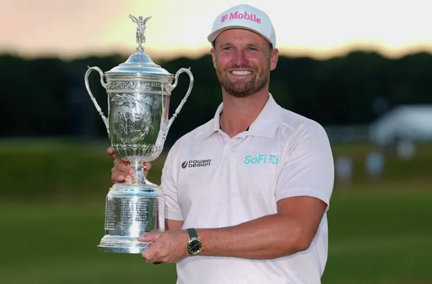 Wyndham Clark holds the trophy after winning the U.S. Open golf tournament at Shinnecock Hills Golf Club in Southampton, N.Y., Sunday, June 21, 2026. (AP Photo/Gerald Herbert)