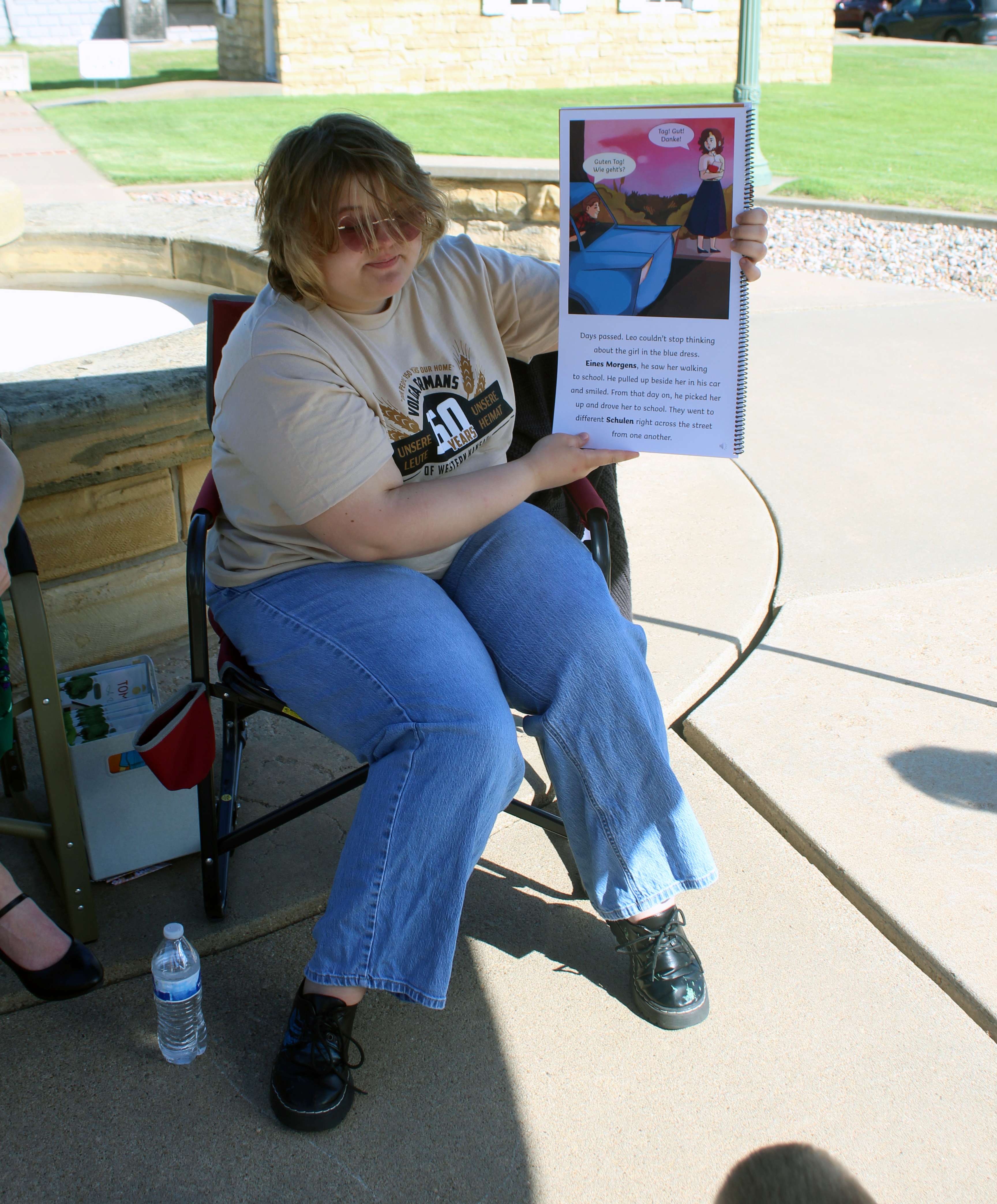 Willow Nickell, Hays High graduate, reads "The Blue Dress," which she illustrated, to a group of students on June 13 at Kinderfest at the Ellis County Historical Museum.&nbsp;Photo by Cristina Janney/Hays Post