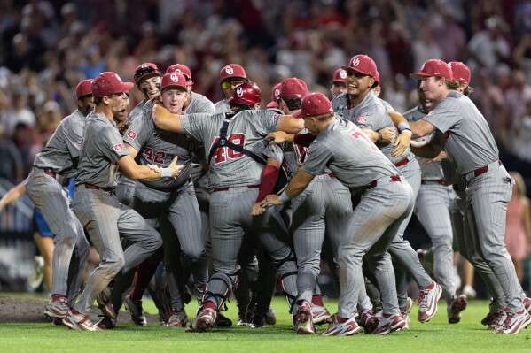 Oklahoma players celebrate after defeating North Carolina in Game 3 of the NCAA College World Series baseball finals in Omaha, Neb., Monday, June 22, 2026. (AP Photo/Rebecca S. Gratz)
