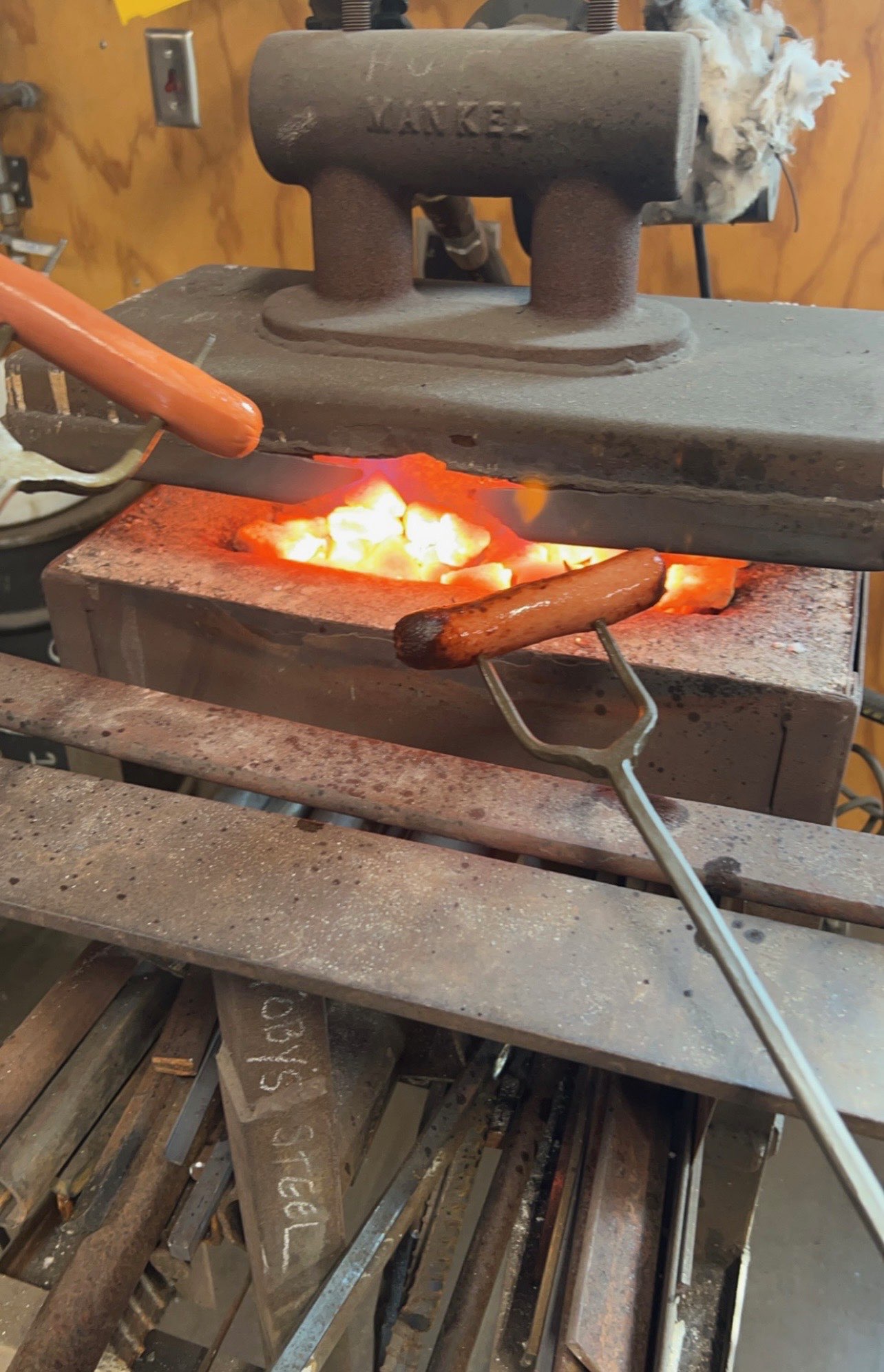 Schluckebier in the foundry environment, highlighting the blend of experimentation and creativeness by grilling hot dogs. Courtesy photo. <br>