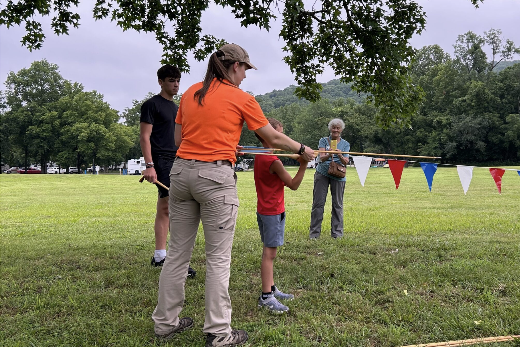 A Missouri state parks employee teaches a young visitor to Sam A. Baker State Park to throw an atlatl, an ancient hunting device used to throw a spear a long distance, during the June 13 celebration of the park’s 100th anniversary (submitted photo).