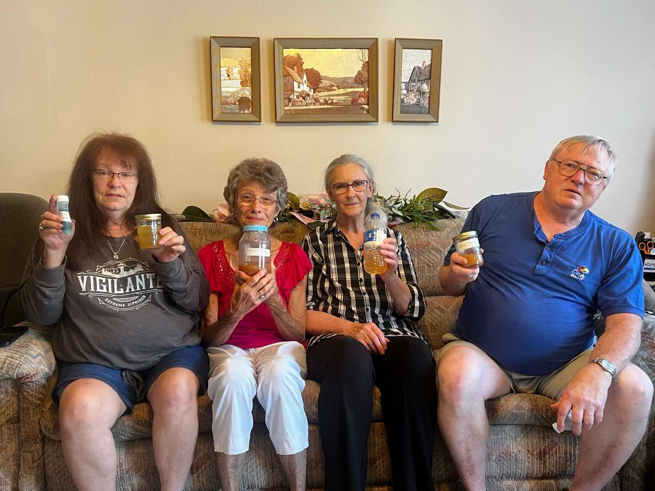 Dover Drive residents holding up discolored and undrinkable water in their west Salina neighborhood. <b>Names in order of picture: </b>Sharee Spratlen, Linda, Debbie &amp; Mike - Photo by Nicolas Fierro 