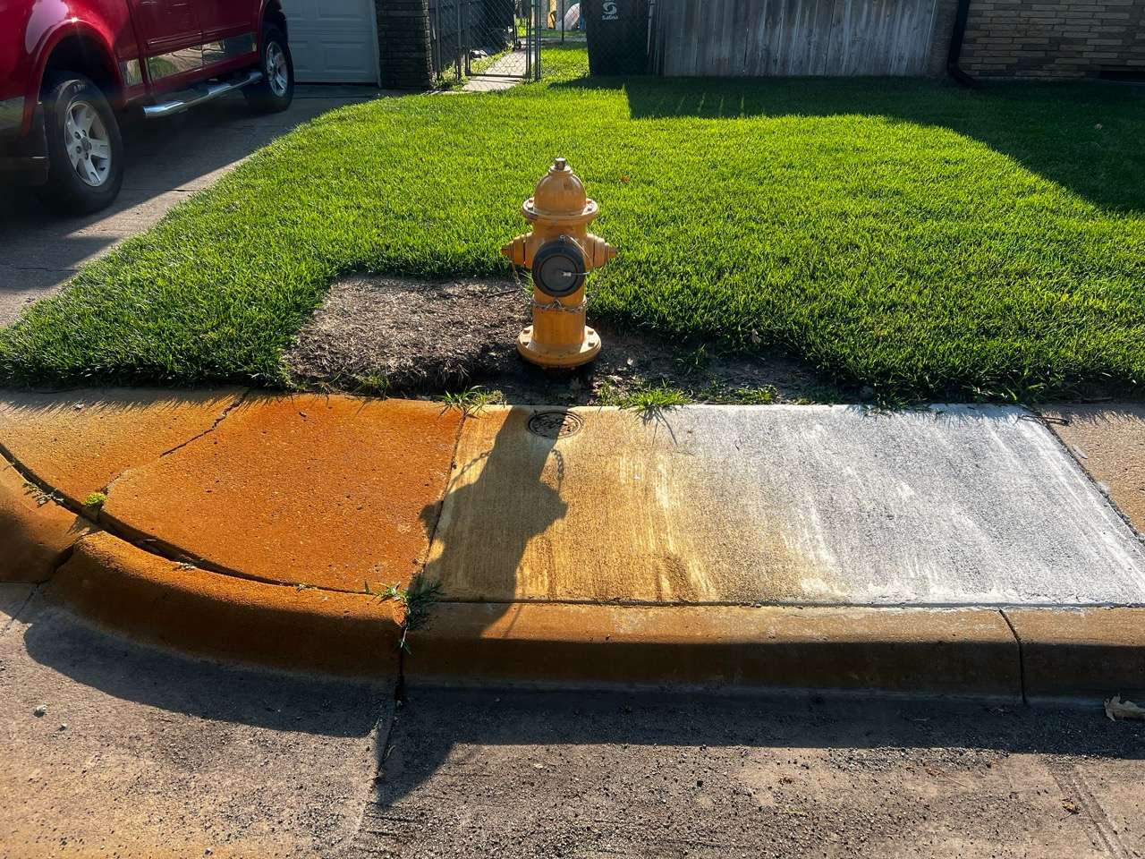 Sidewalk along Dover Drive, showing rusted/orange color - Photo taken by Nicolas Fierro on June 23, 2026