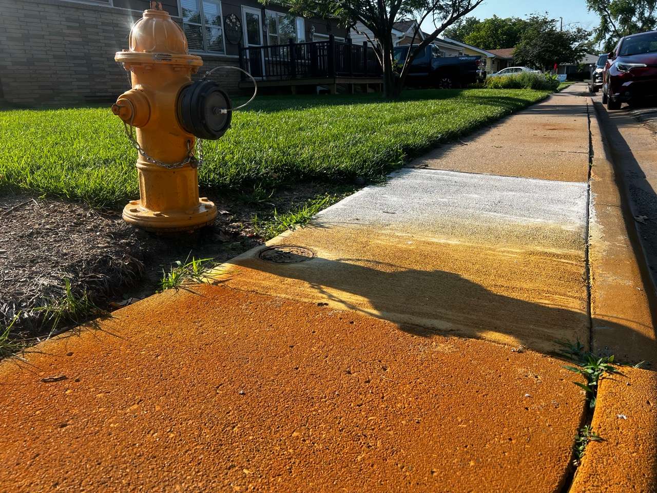 Sidewalk along Dover Drive, showing rusted/orange color - Photo taken by Nicolas Fierro on June 23, 2026