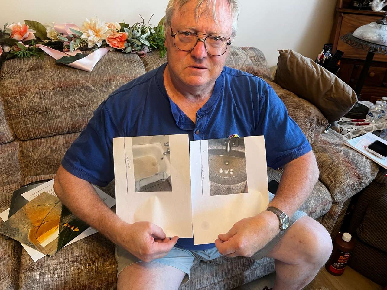 Dover Dr. resident, Mike shows pictures of discolored water in his home - Photo by Nicolas Fierro