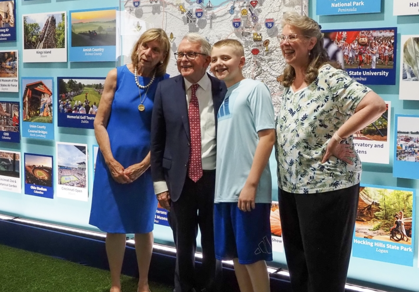 From left, Ohio first lady Fran DeWine and Gov. Mike DeWine take a photo with Miles Armiger, 12, of Severn, Maryland, and his grandmother, Robyn Toman, on Thursday, June 25, 2026, at the Ohio exhibit, part of the Trump administration’s Freedom 250 Great American State Fair. (Photo by Ashley Murray/States Newsroom)
