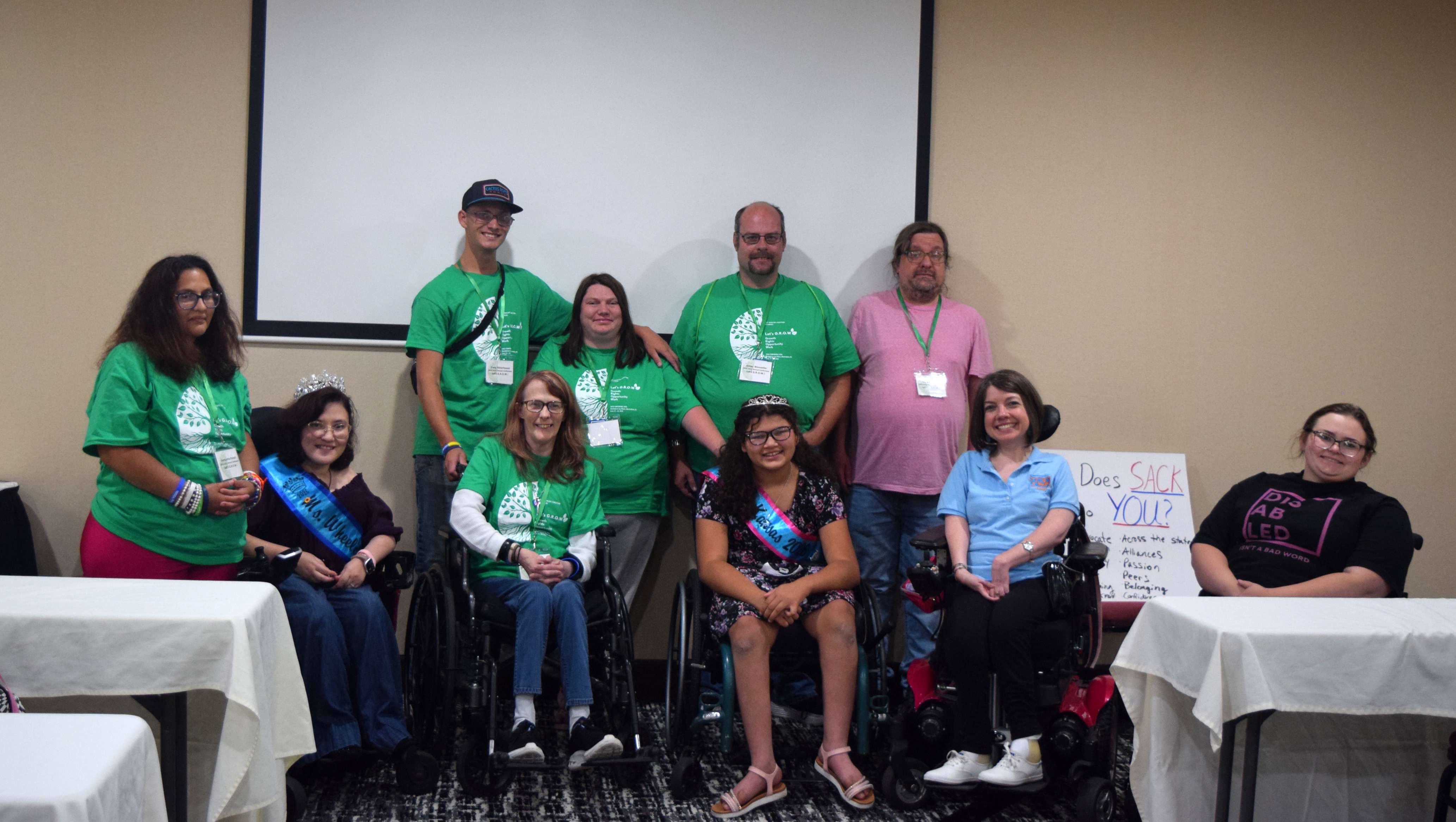 Rosewood attendees in their green shirts pause for a group moment with fellow participants at the SACK Conference in Manhattan, held June 19–21. Rosewood representation, left to right: Samantha Purcell, Trace Ritterhouse, Pam Babcock, Courtney Adams, and Jim Wonsetler. The two sash winners are left to right, Ms. Wheelchair Kansas - Magda Carlos-Trevino and Little Miss Wheelchair Kansas - Naomi Bartley.