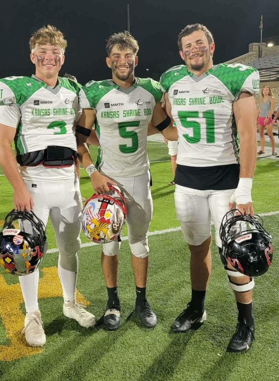 Great Bend's Daxton Minton (3) and Trenton Kern (51) along with Hoisington's Taylen Morales (5)
