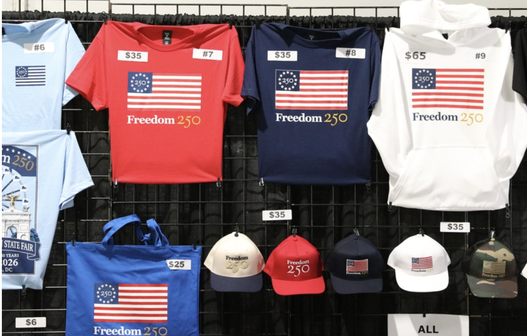Shirts tied to America’s 250th birthday are sold in a stall at Freedom 250’s Great American State Fair in Washington, D.C., on June 30, 2026. (Photo by Sam Gauntt/States Newsroom)