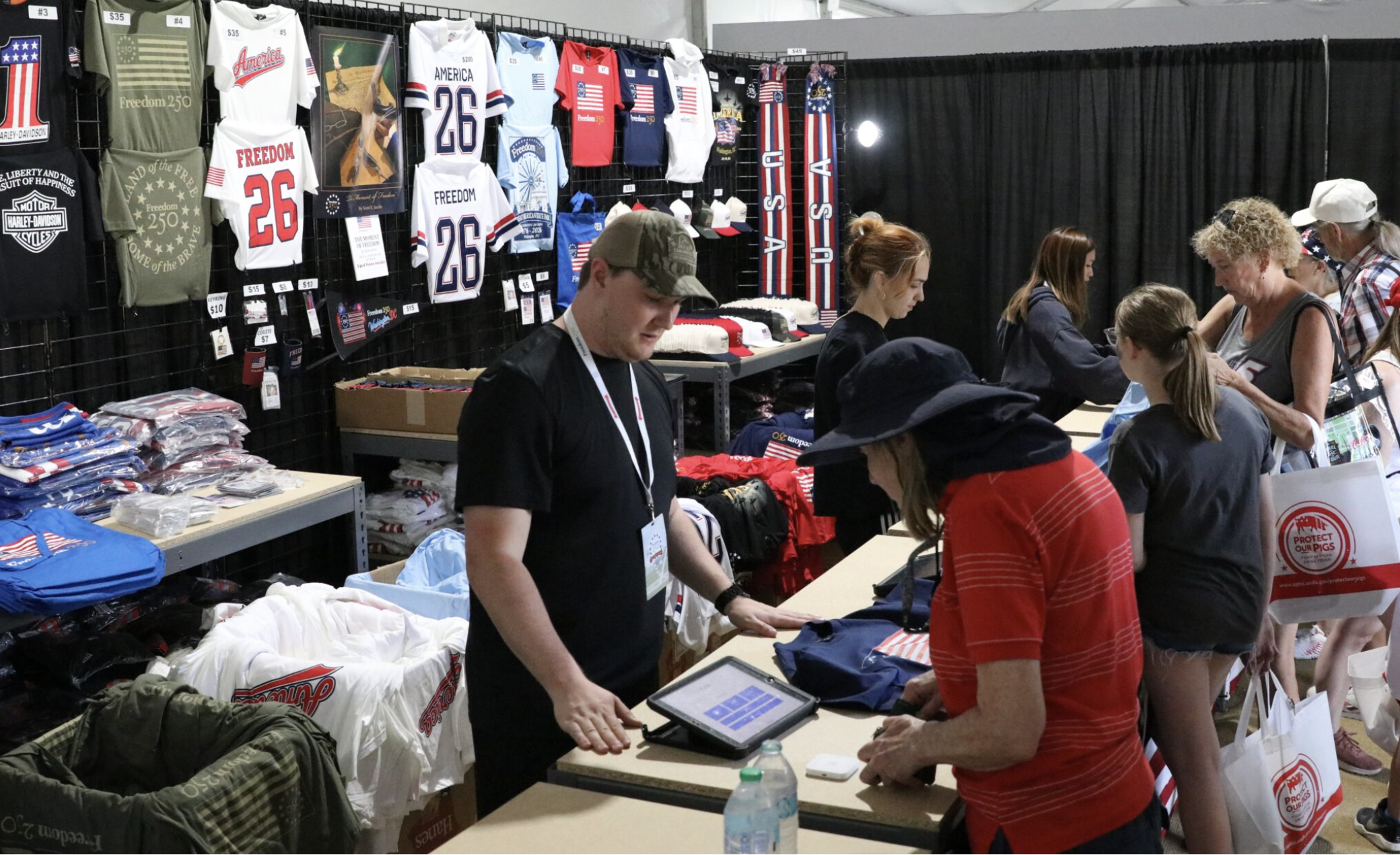 Merchandise tied to America’s 250th birthday is sold in a stall at Freedom 250’s Great American State Fair in Washington, D.C., on June 30, 2026. (Photo by Sam Gauntt/States Newsroom)