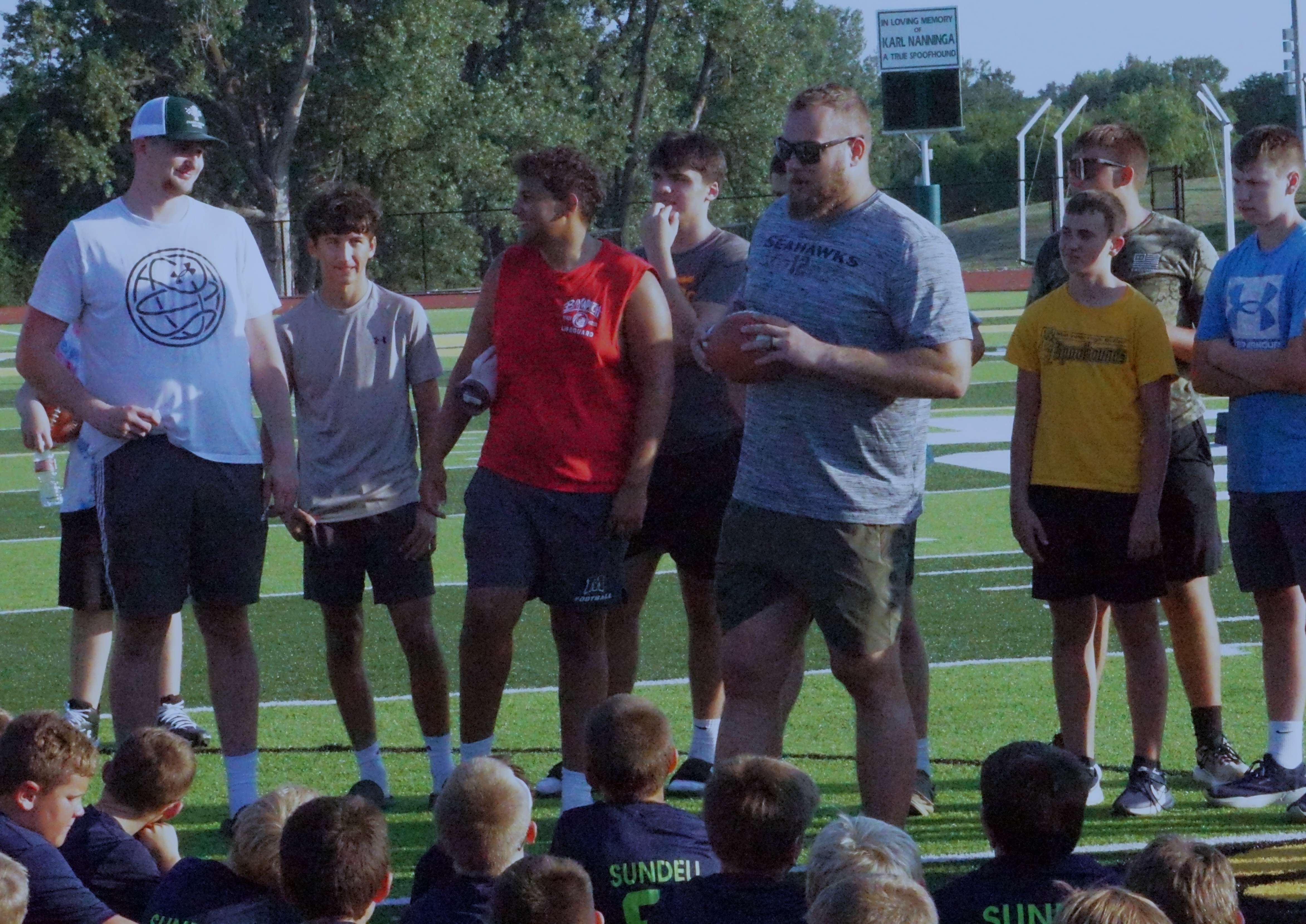 Jalen Sundell wraps up his youth football camp with a final huddle/ Photo by Matt Pike