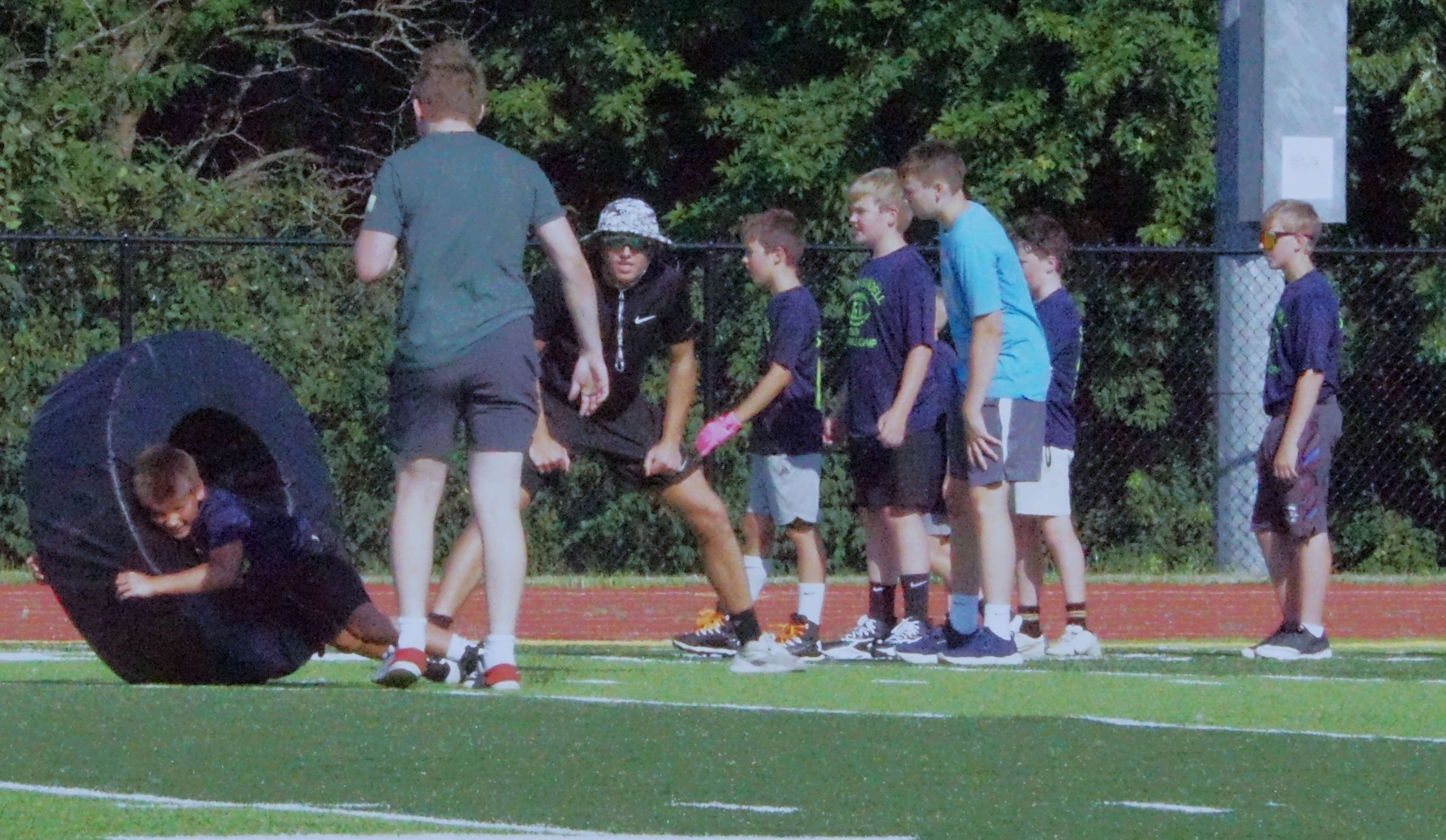 Students run through a tackling drill/Photo by Matt Pike