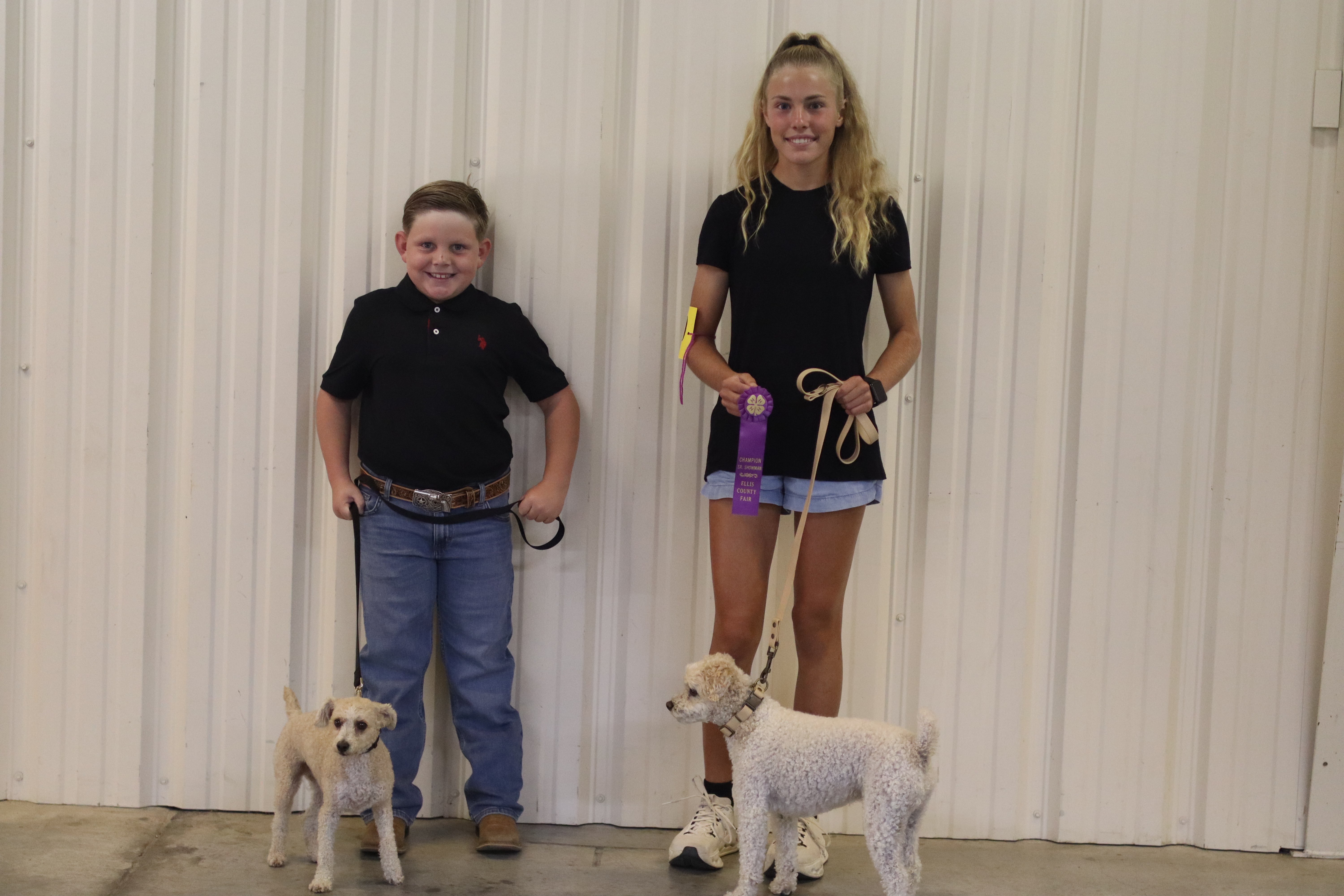 Reddin and his dog Bingo, left, stand next to the Showmanship Grand Champion, Audrey and her Bichon Frise, Chibro. Photo by Alin Hett/Hays Post