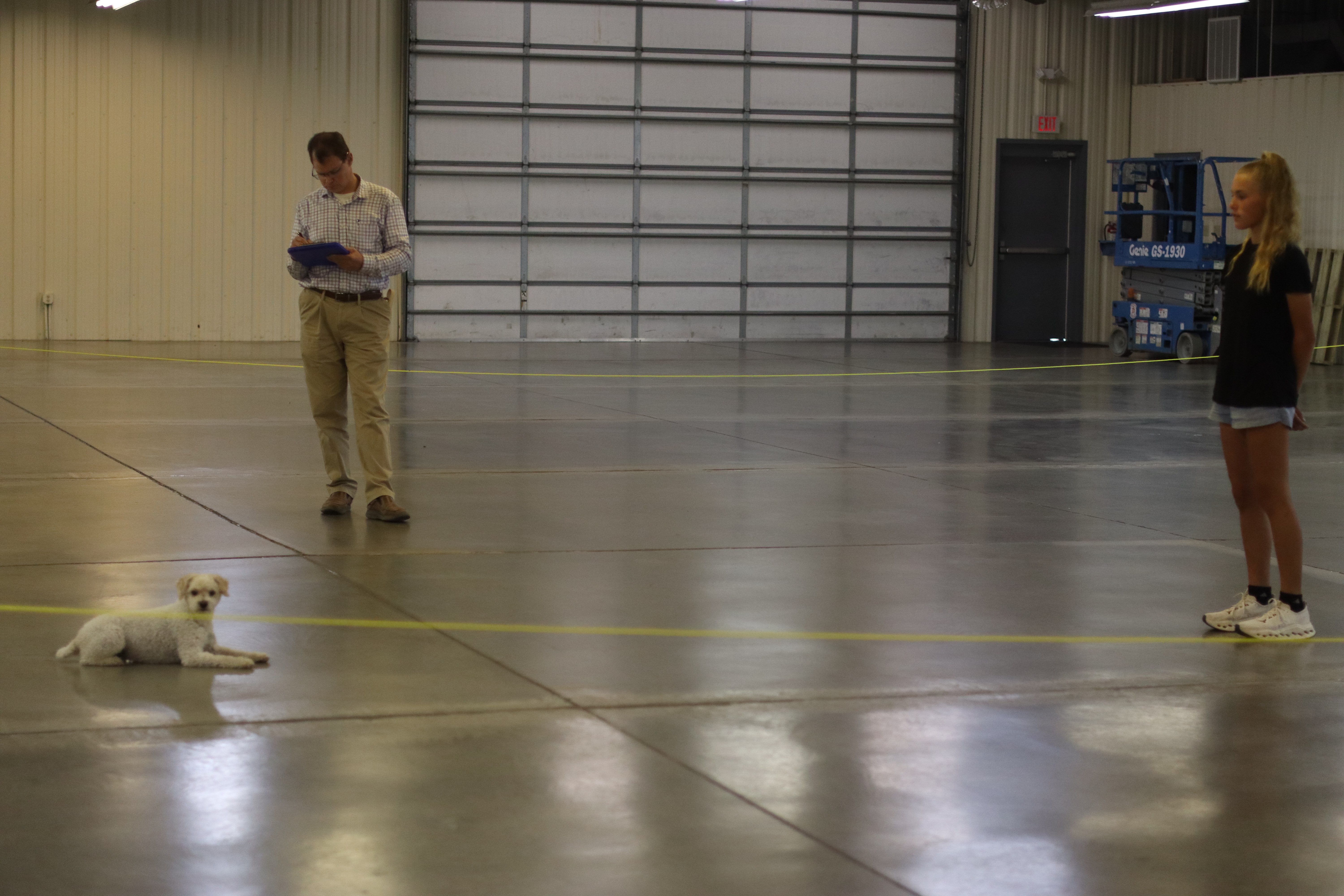 Audrey and Chibro during the Obedience category as Judge Will Clark takes notes. Photo by Alin Hett/Hays Post.&nbsp;