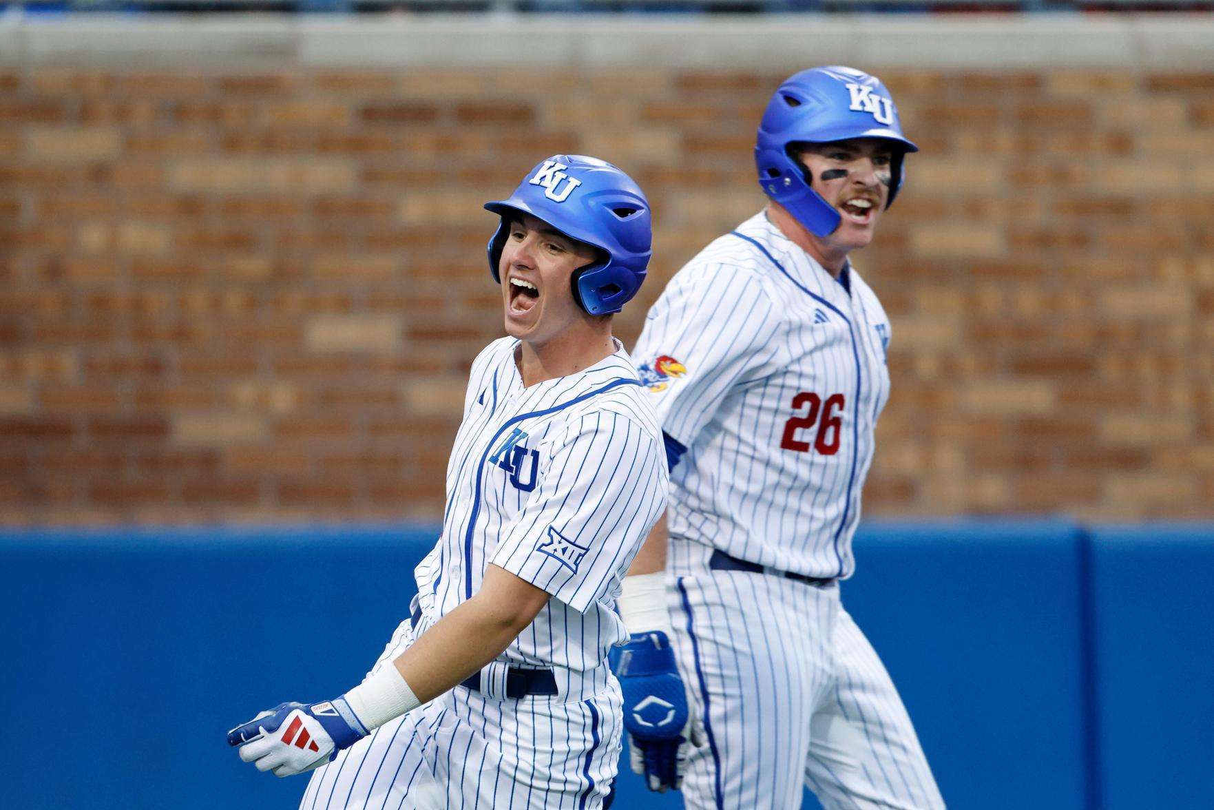  Kansas' Tyson LeBlanc, left, and Brady Ballinger (26) react after scoring off a Dariel Osoria single during eighth inning of an NCAA college baseball game against St. Thomas on March 5, 2026, in Lawrence, Kan. (AP Photo/Colin E. Braley, file)