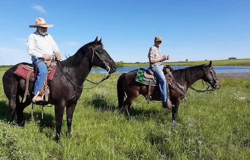 Seth Lauer (on the left) with a friend as they ride through pastures - photos courtesy of the Lauer family.