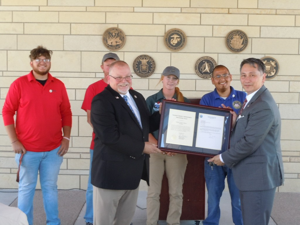 Veterans Cemetery Grants Program Director James Earp (front right) presents the NCA Stewardship Award to Cemetery Manager James Goodwin. Behind them are (from left to right) NVCA public servants Peyton Hornung, Danny Blow, Alisha Coffee, and Jacob Hernandez.