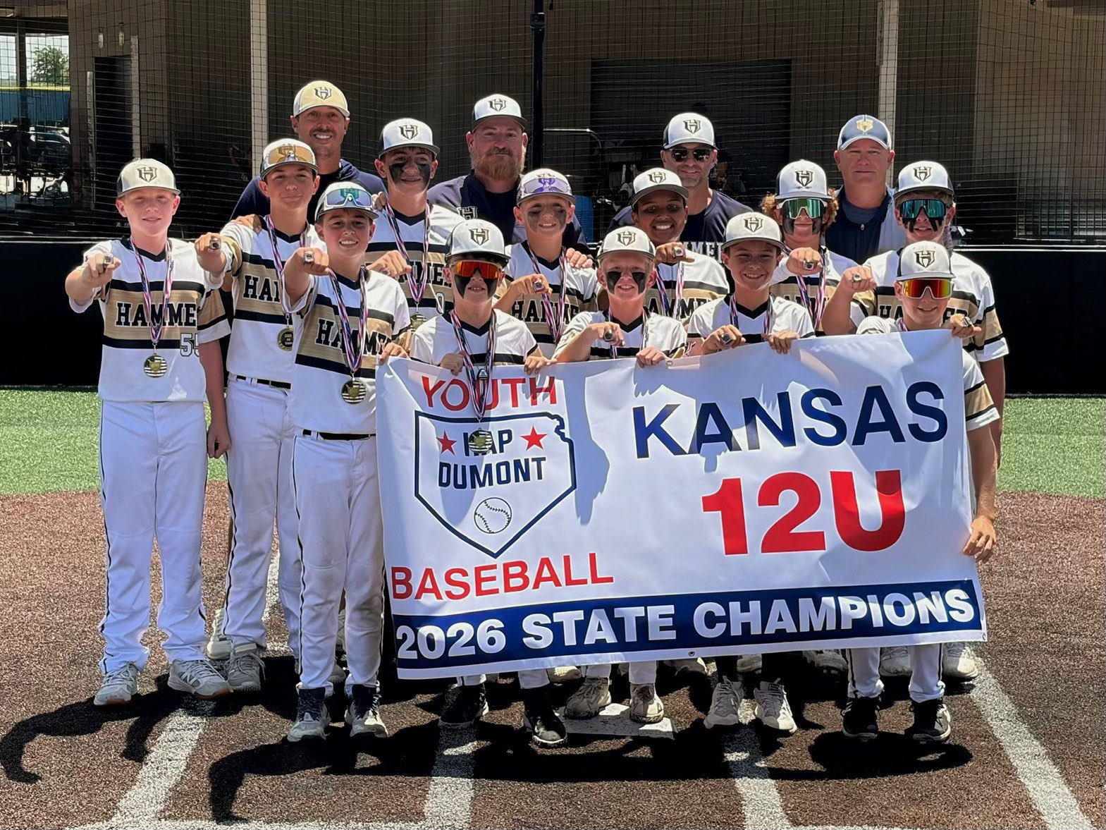 Hammer-Pfeifer baseball club poses after winning the Kansas 12U 2026 State Championship. Front row, from left: Quintyn Bauck, Nolan Clark, Mason Haselhorst, Jackson Pfeifer and Braxton Hart. Middle row, from left: Grayson Tuzicka, Bentley Gerstner, Creed Morgan, Kellan Augustine, Jaylin Irvin, Colin Dinkel and Liam Wise. Back row, from left: Coaches Jason Pfeifer, Allen Morgan, Derek Gerstner and Danny Dinkel. Not pictured is Ansen Mortinger. Courtesy photo. 