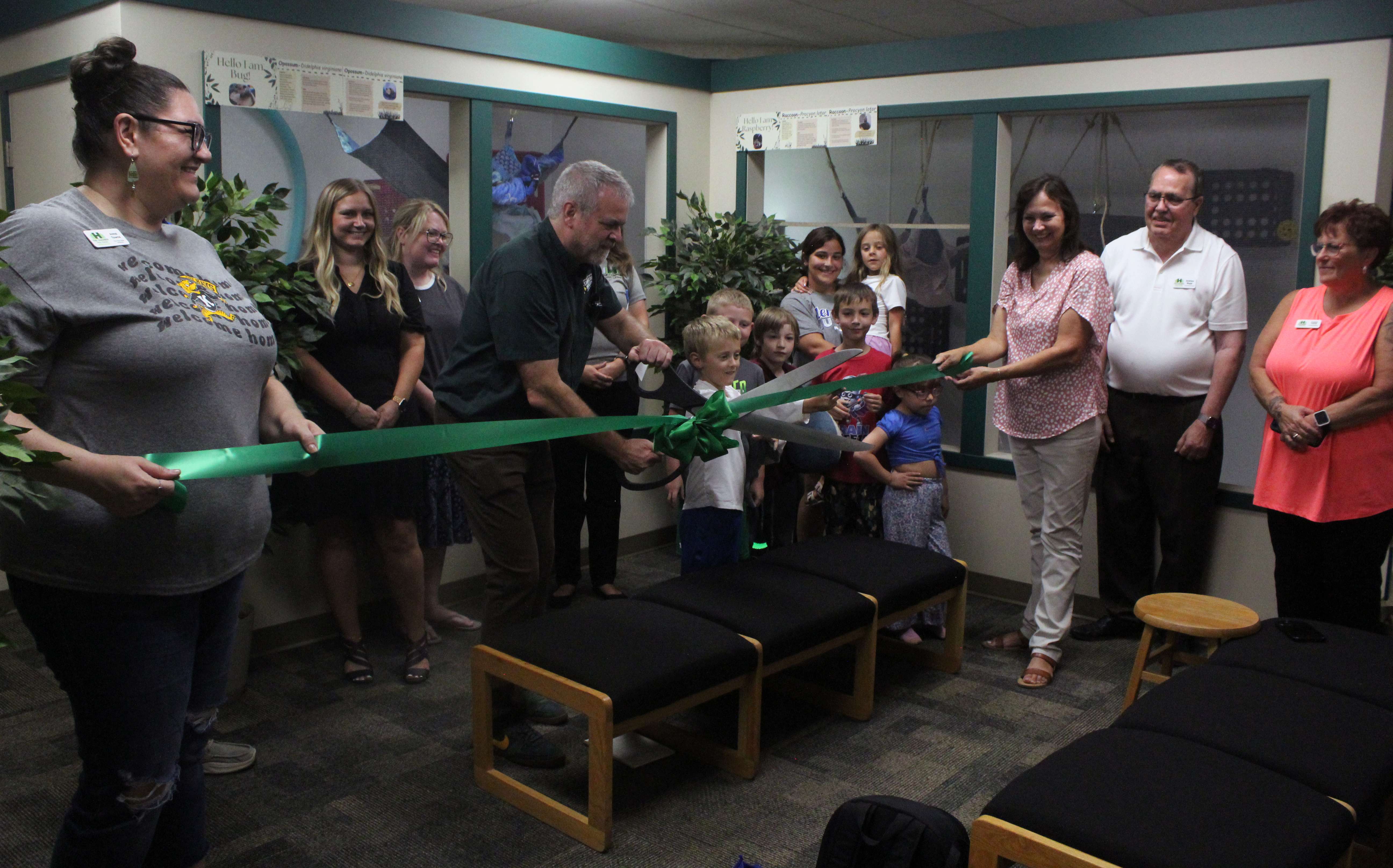 Sternberg Executive Director Reese Barrick cuts the ribbon on the new mammal habitats in the Sternberg Museum Discovery Room at a Chamber in Hays Chamber Chat on July 7. Photo by Cristina Janney/Hays Post