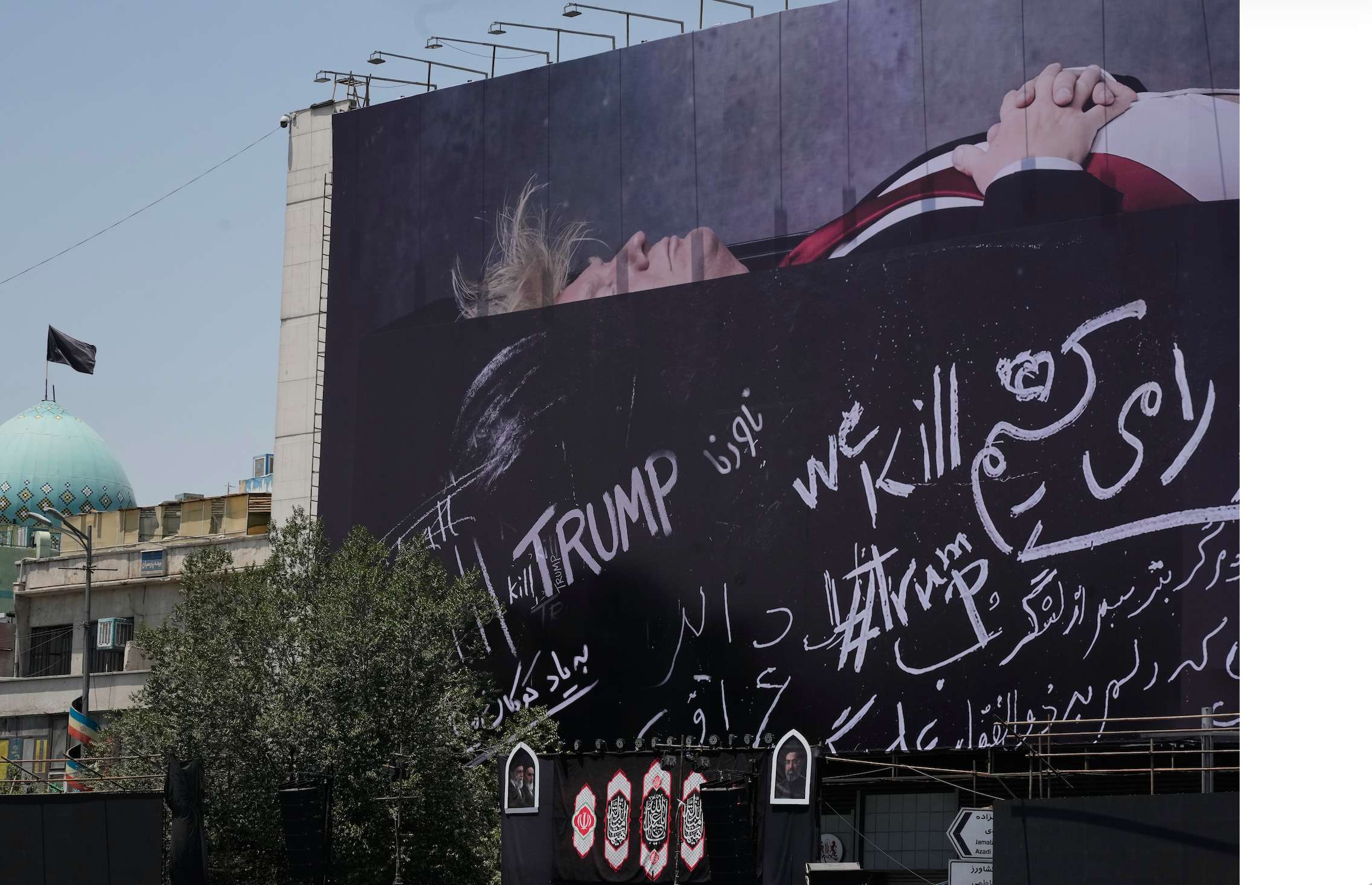 A billboard depicting U.S. President Donald Trump lying on what appears to be a coffin and bearing anti-Trump messages, including the phrase "We Kill Trump," is seen at Islamic Revolution Square in downtown Tehran, Iran, Wednesday, July 15, 2026. (AP Photo/Vahid Salemi)