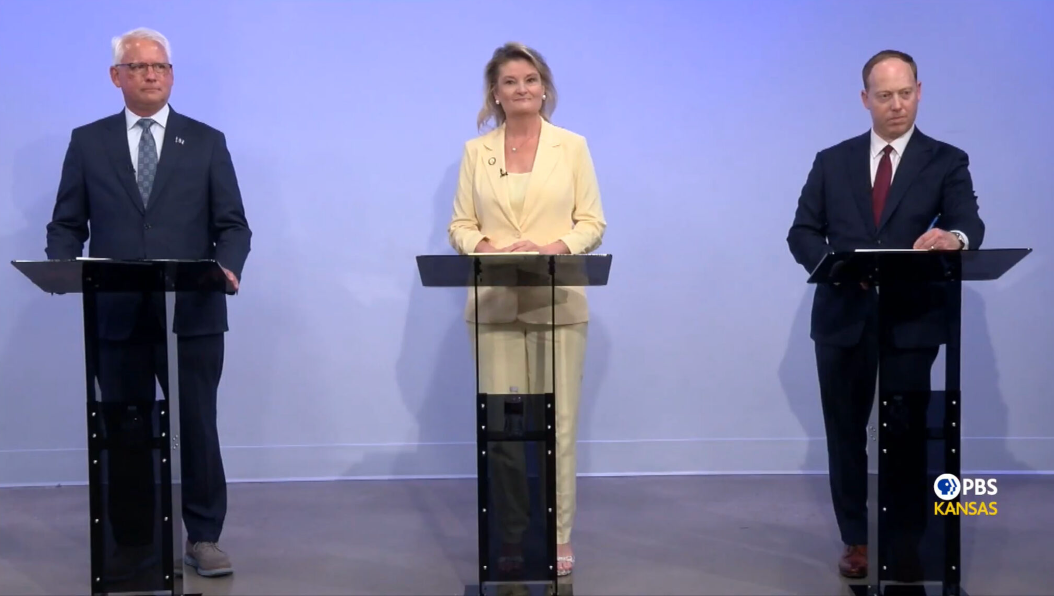 From left, Democrats Curt Skoog, Cindy Holscher and Ethan Corson share their views on a looming budget problem and the deal to bring the Chiefs across state lines during a gubernatorial debate broadcast July 16, 2026, by PBS Kansas. (Screen capture from PBS Kansas video)