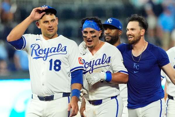 Kansas City Royals' Nick Loftin, right, celebrates with Josh Rojas, center, after Loftin hit a bunt single to drive Rojas in for the winning run during the ninth inning of a baseball game against the San Francisco Giants, Monday, July 20, 2026, in Kansas City, Mo. (AP Photo/Charlie Riedel)