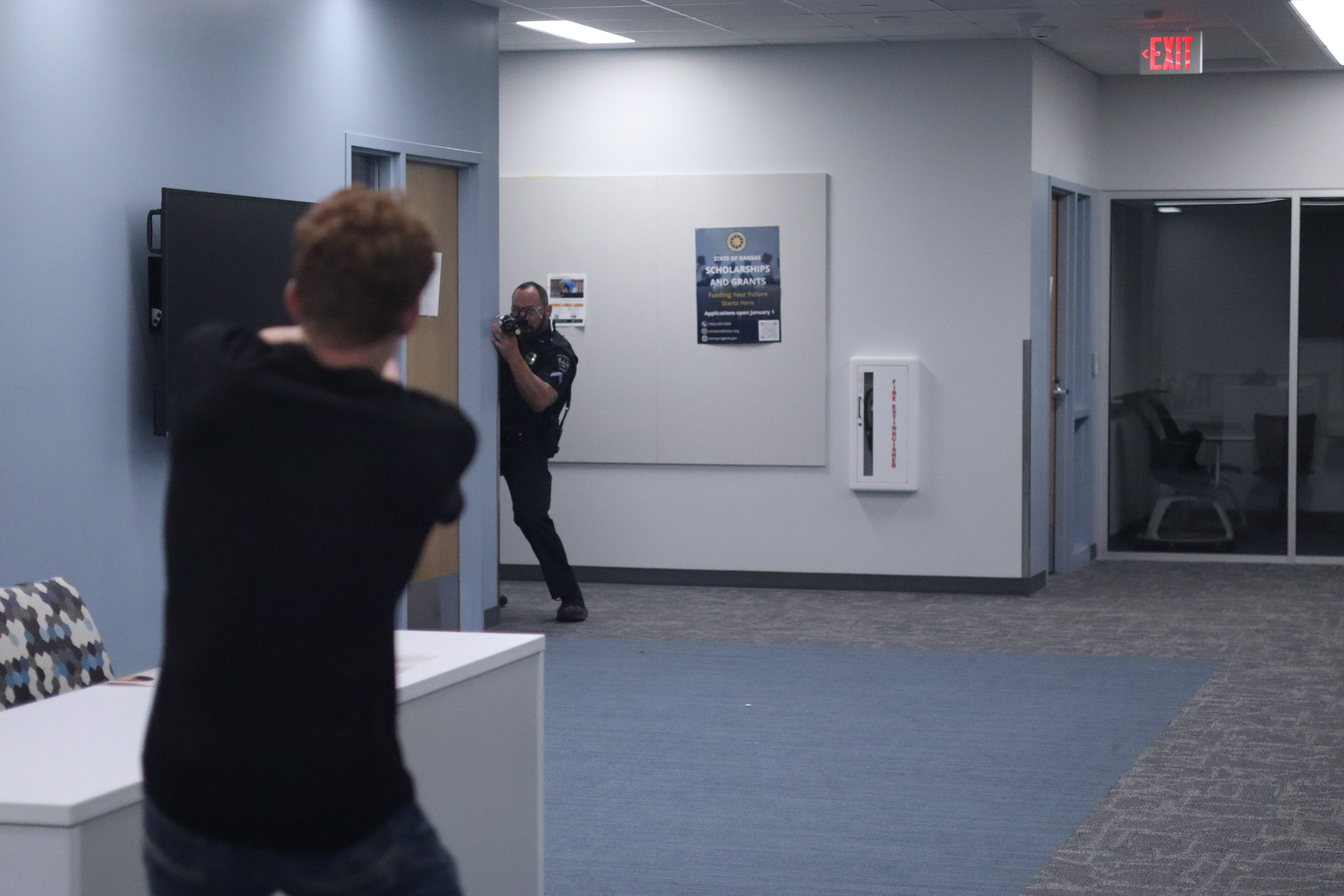 Hays Police Department officerse take down a simulated suspect during an active shooter training exercise at Hays High School.<br>